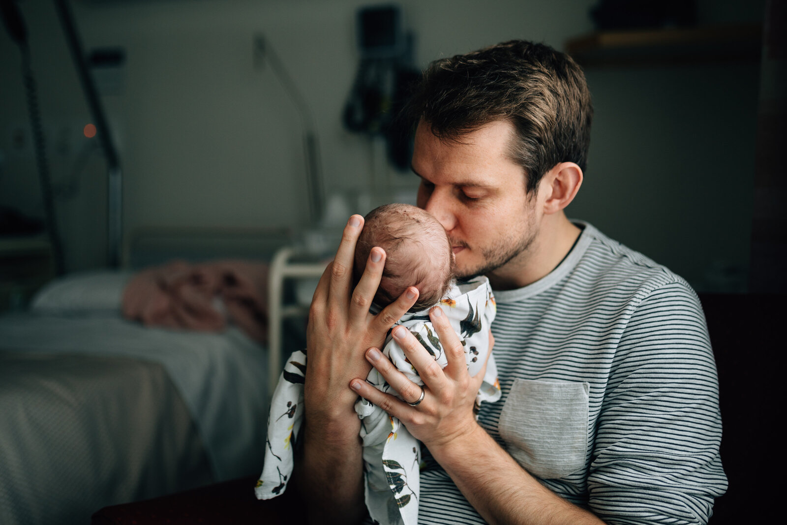dad in hospital room lifting baby up to smell and kiss her, fresh 48 photography melbourne