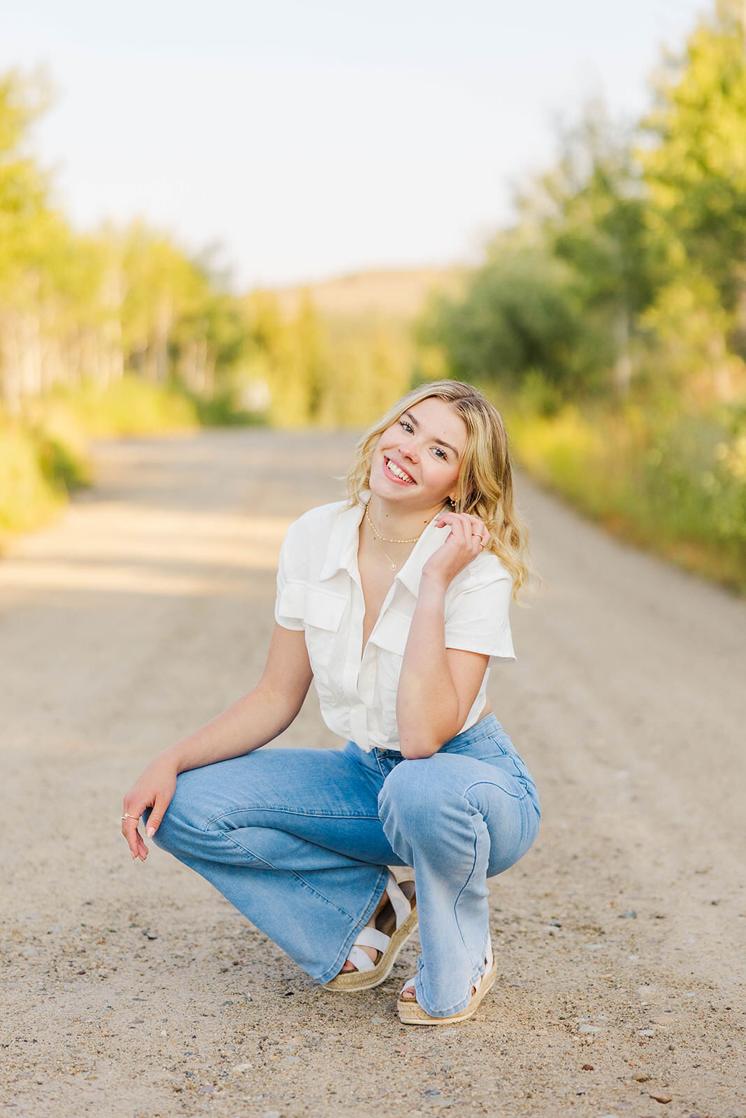 Girl posing for her high school senior photos near Pinedale, Wyoming.
