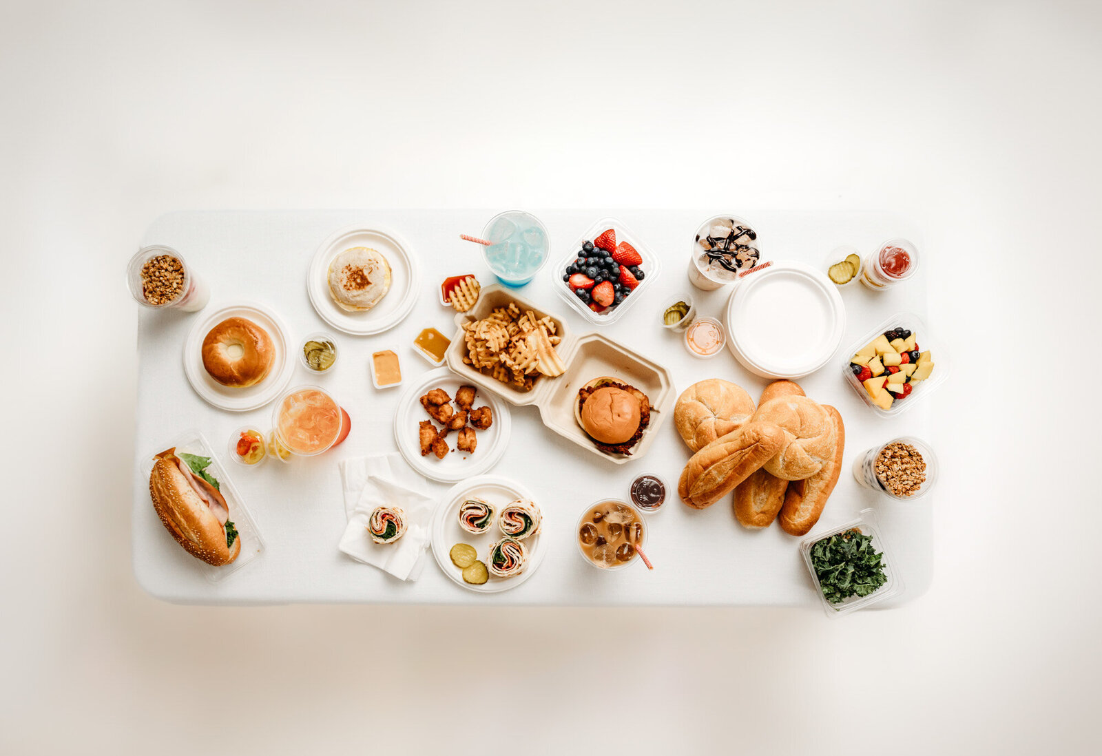 flat lay of fast food and snack food sitting on a table