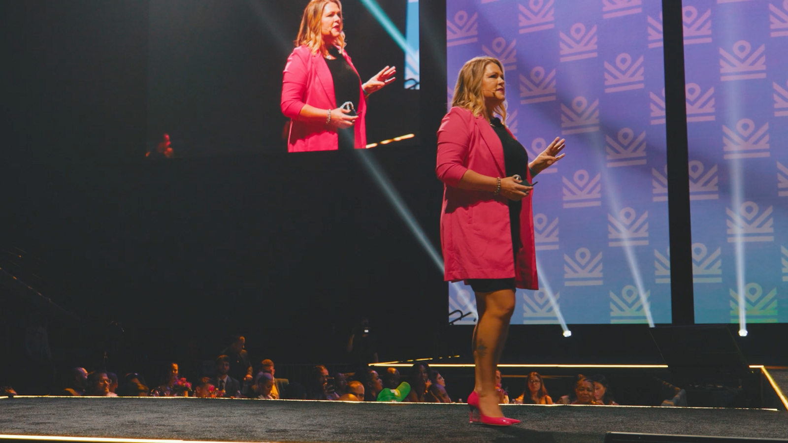 Business coach Melanie Greenough speaking on a stage