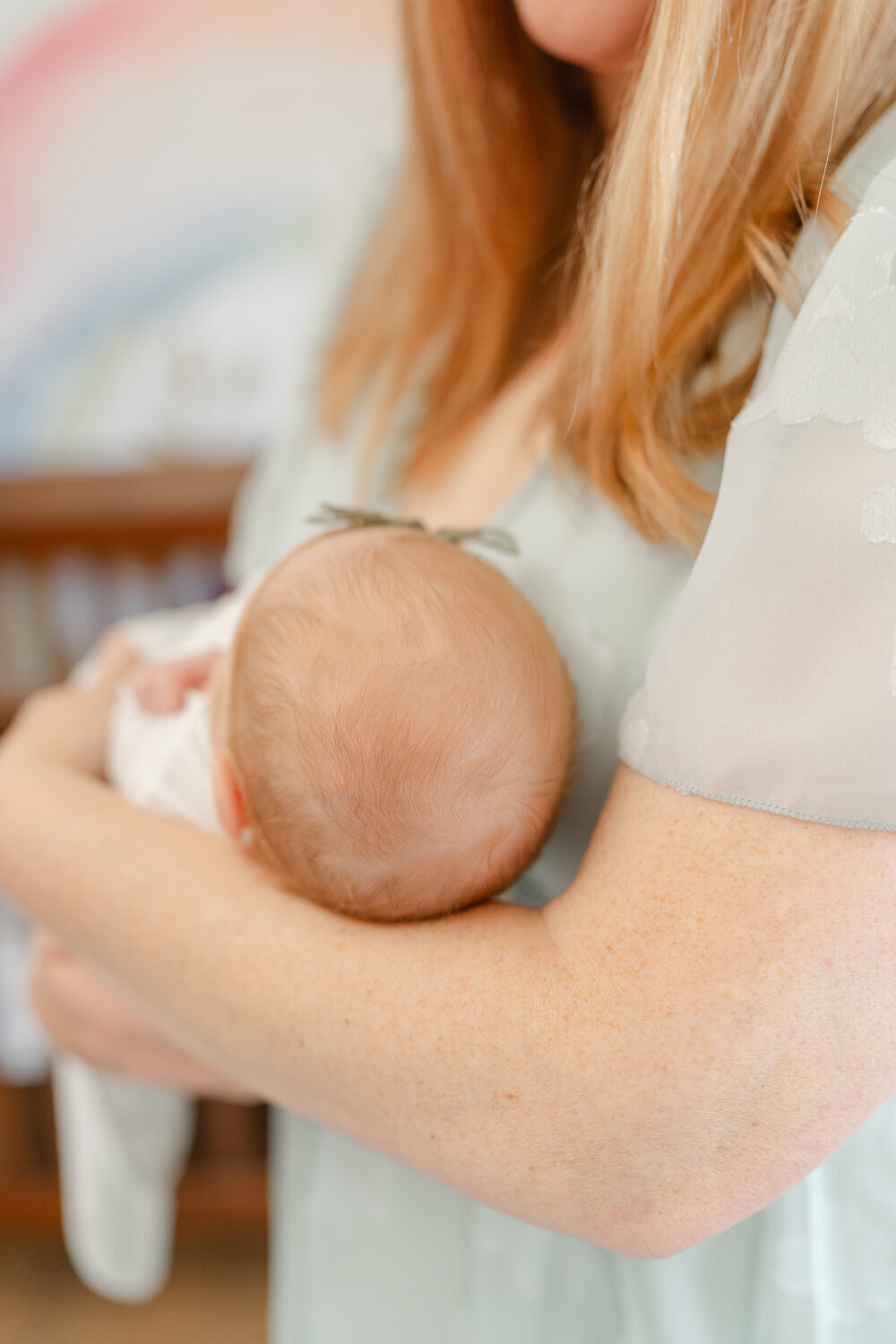 close up of baby's head while held by mom during McLean, VA newborn session
