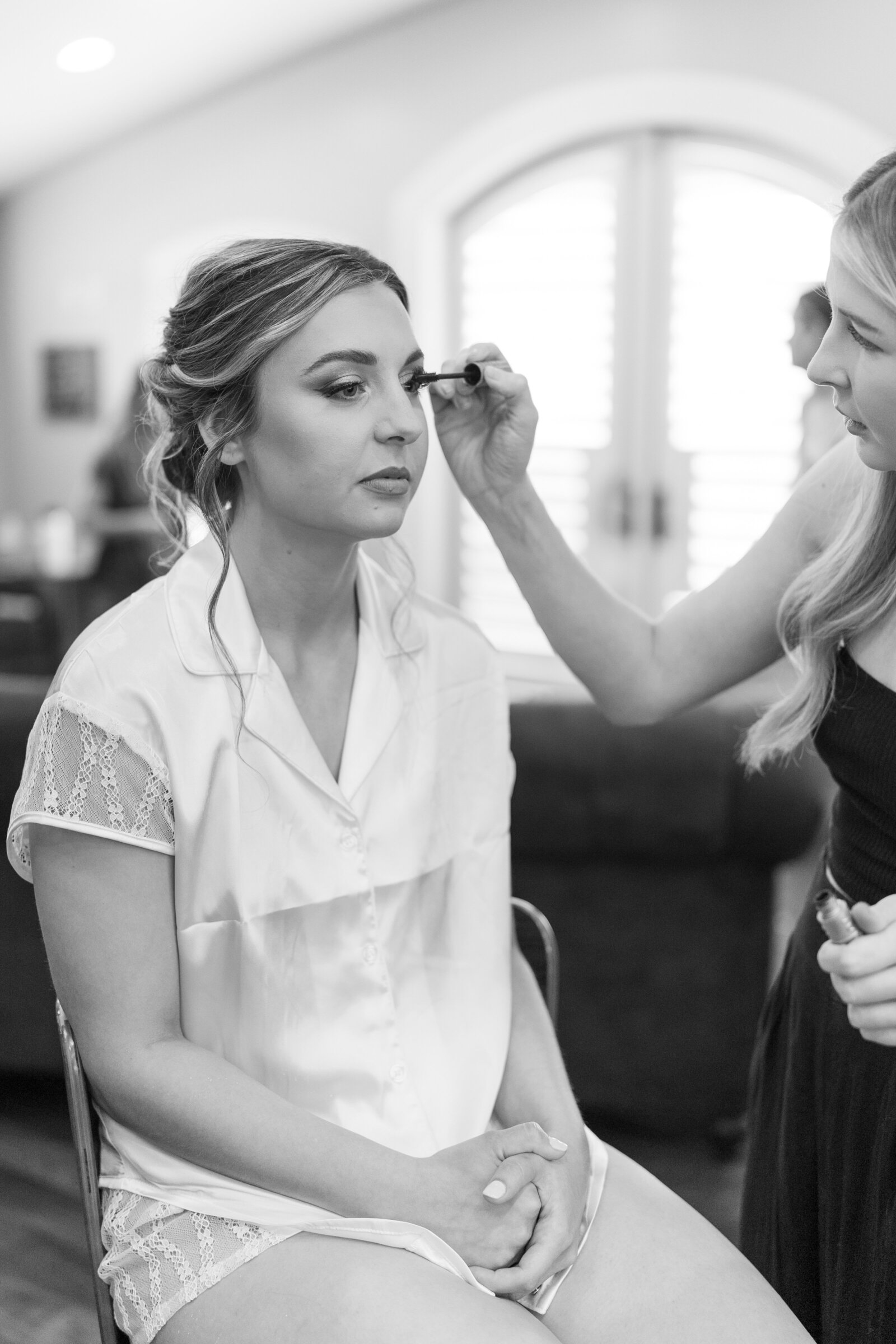The bride prepares for her destination wedding day, captured in a luxurious beach resort with the ocean in the background.