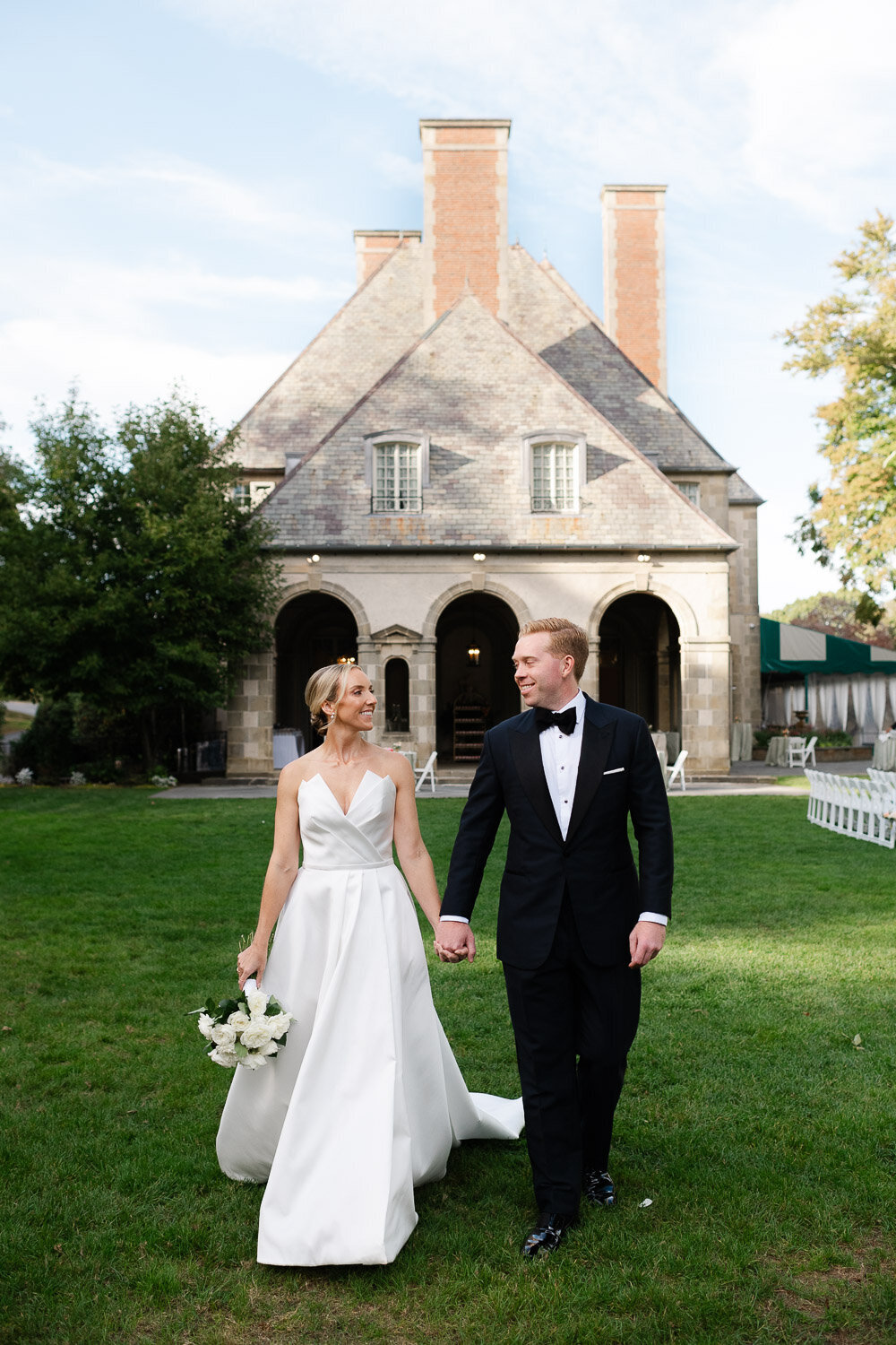 bride and groom walk in front of glen manor