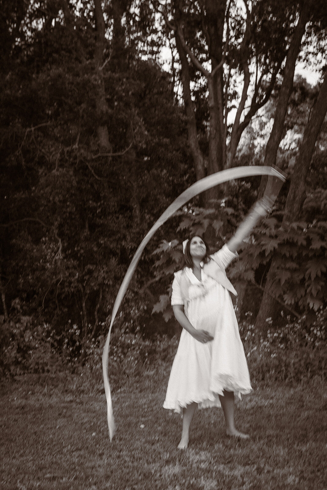 mother with twirling ribbon, maternity session, dancing, fun, cottage core look