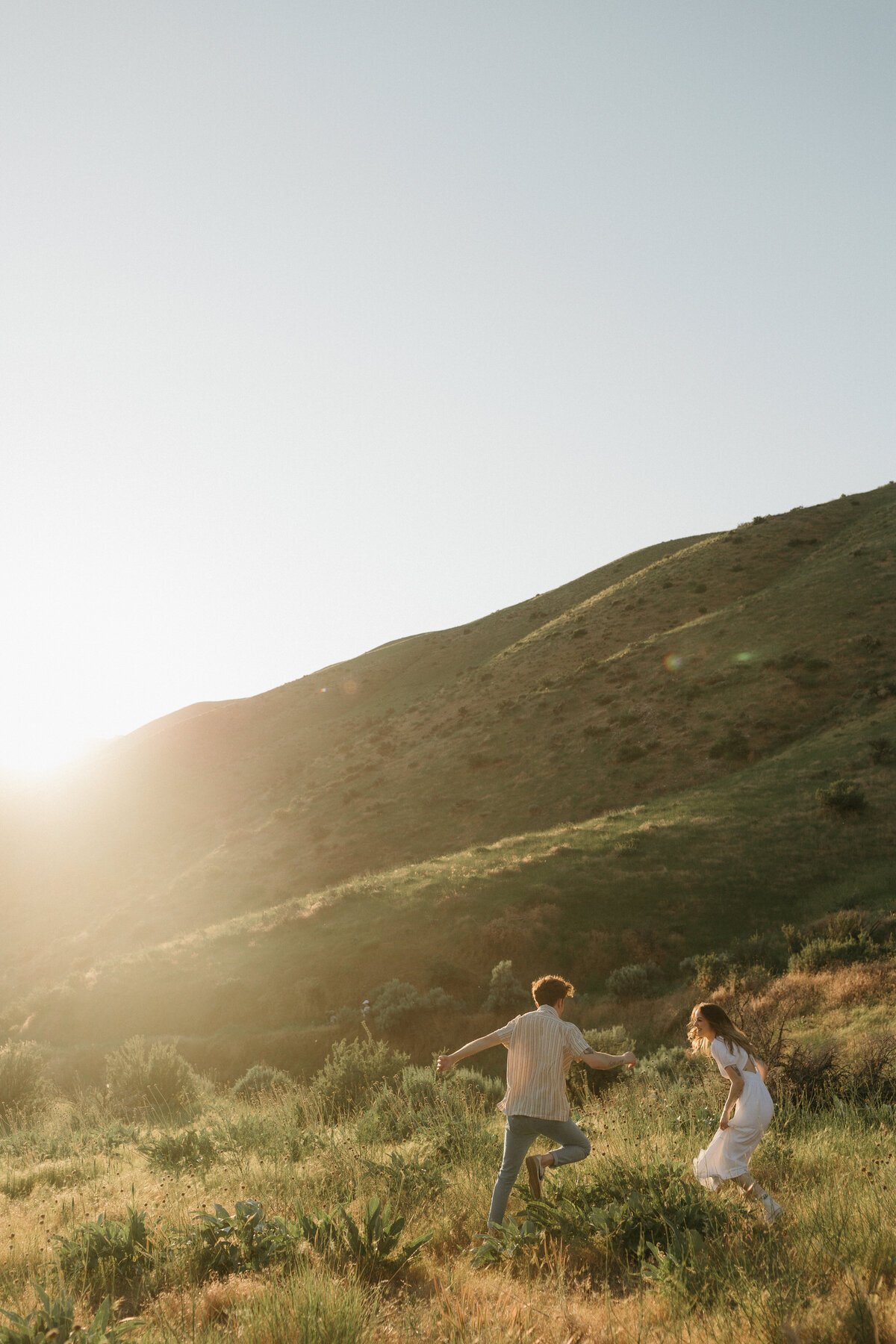 Couple on hillside by destination wedding photography expert
