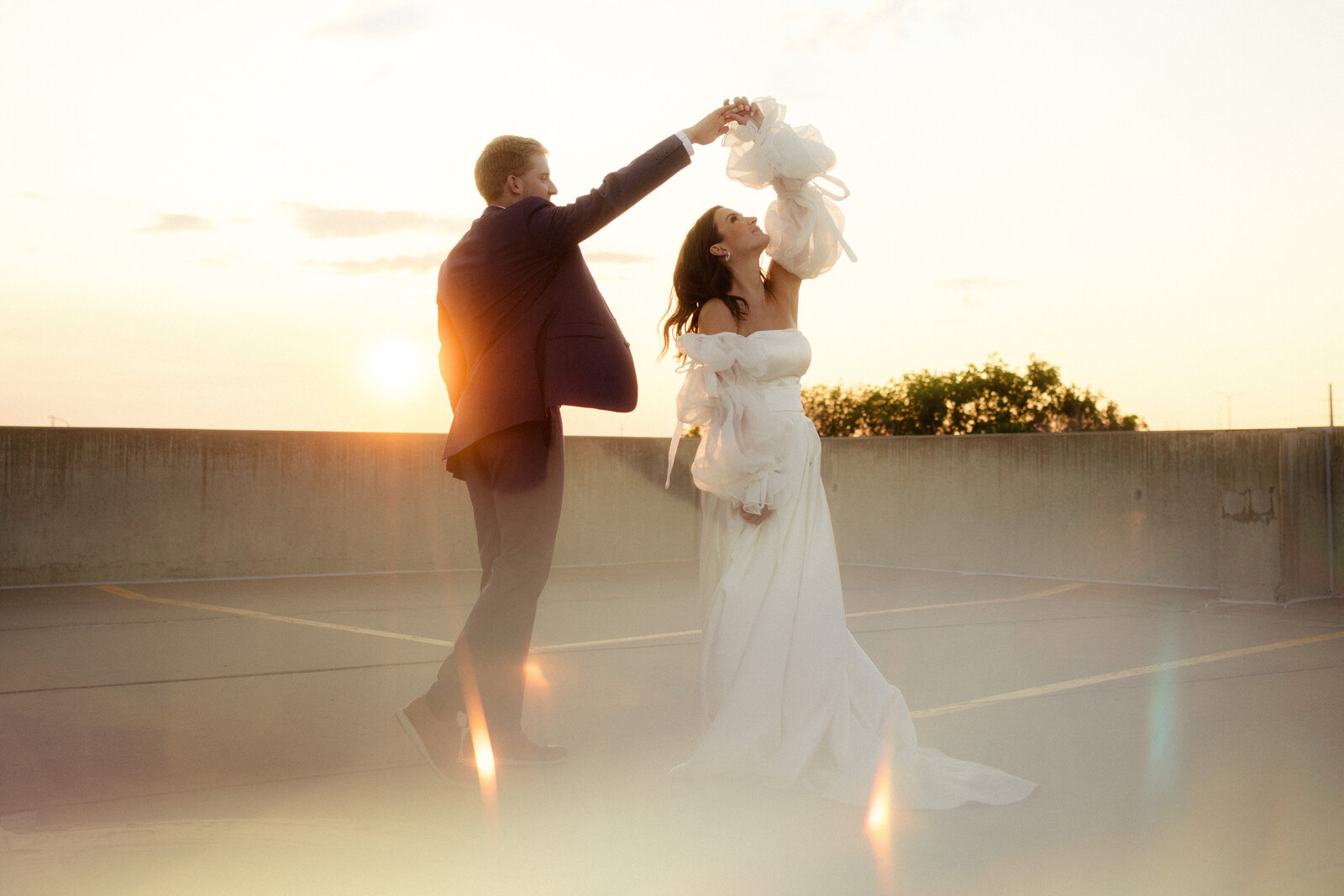 Bride spins under sparkling sunset