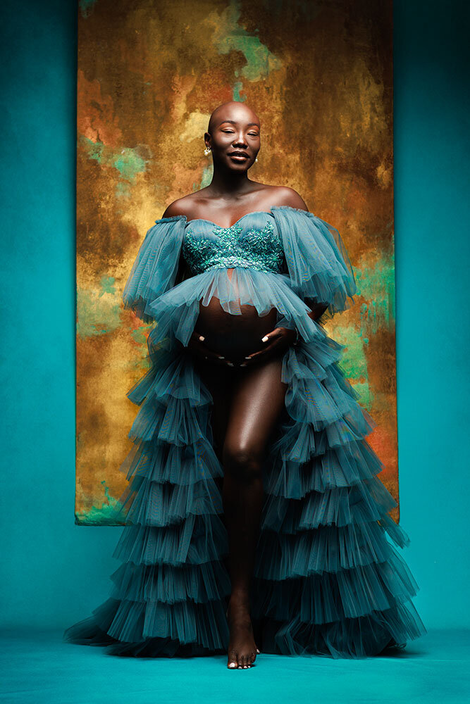 black-woman-maternity-beautiful-elegant-classy-turquoise-dress-flowy-stunning-painted-studio-background-paramount-lighting-luxury-best-colorado-maternity-photographer