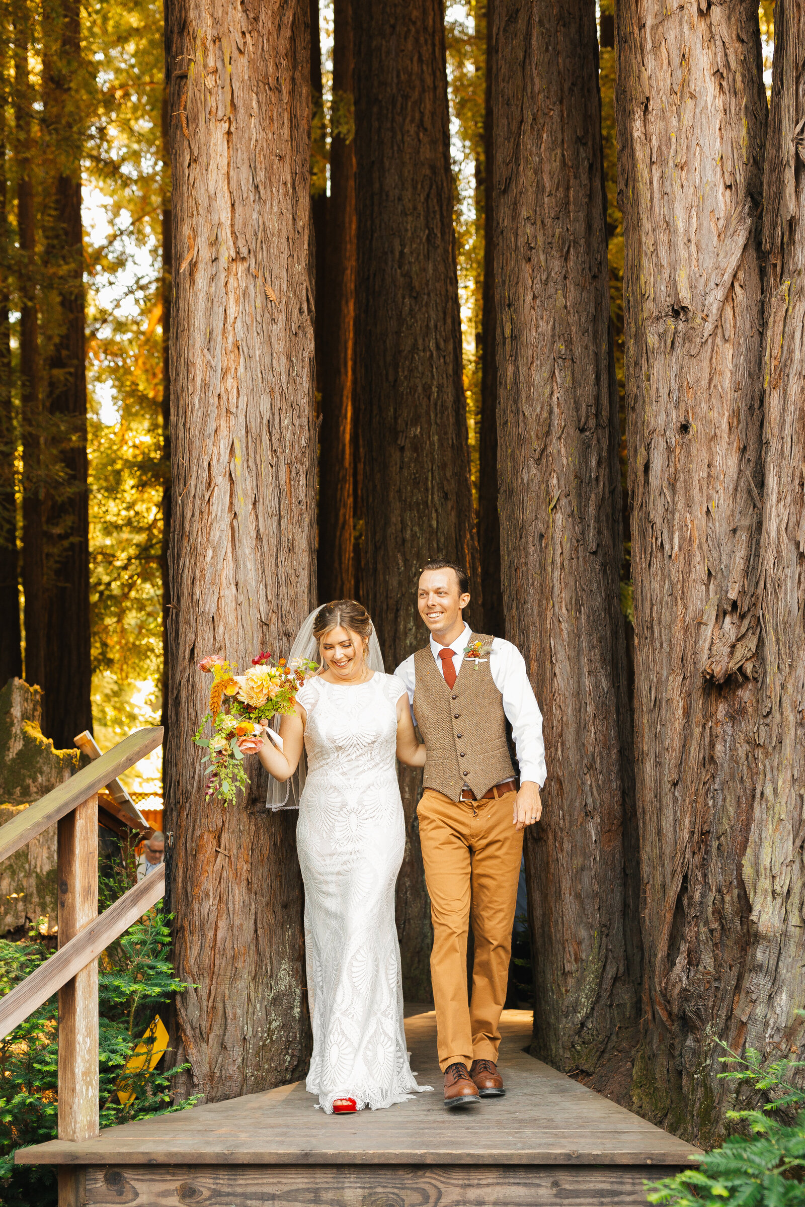 Bride and groom on their colorful wedding day in Santa Cruz, California in the redwood trees.