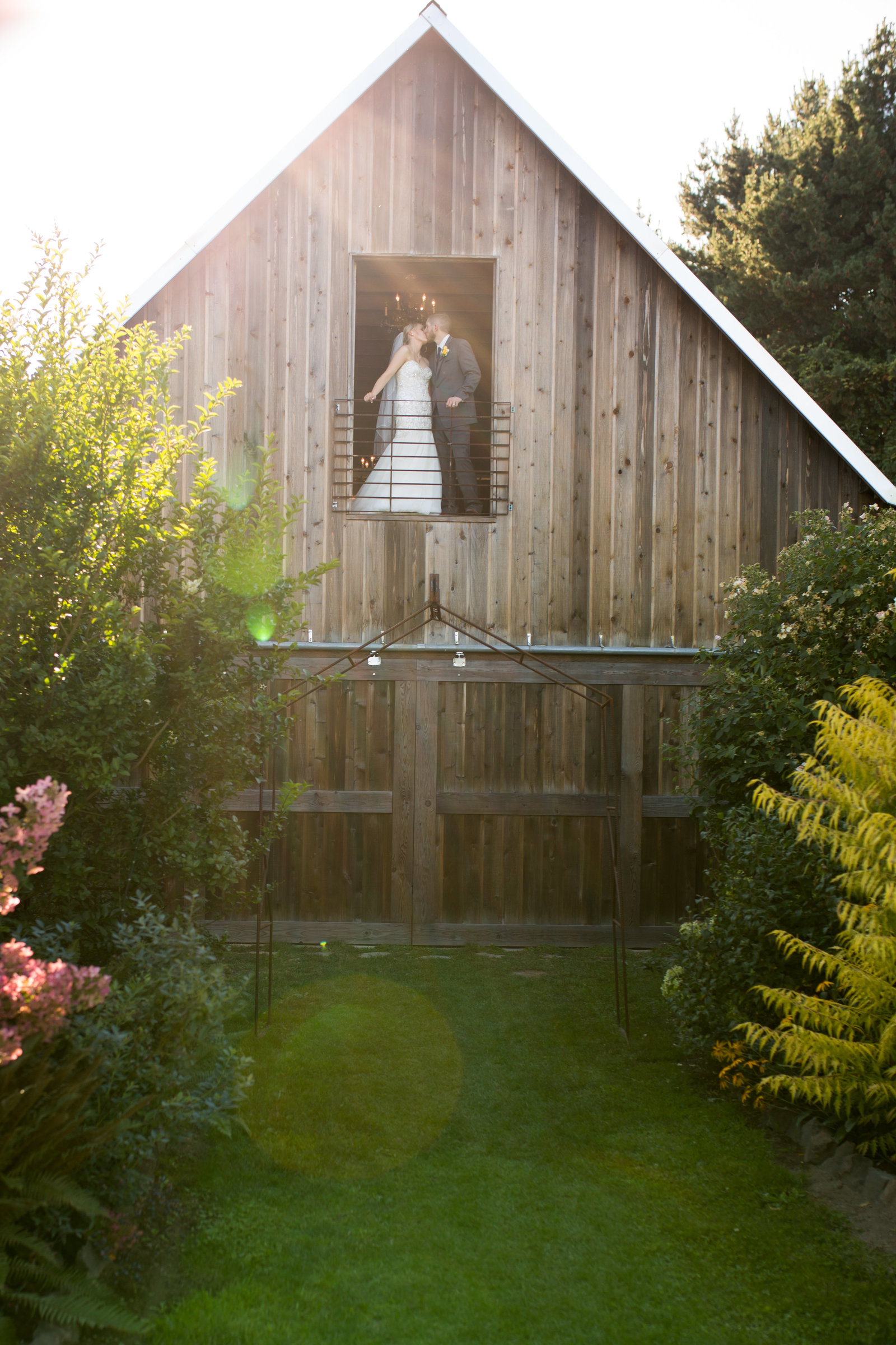 tacoma washington wedding photographed at outdoor barn venue with sunflowers and bride and groom