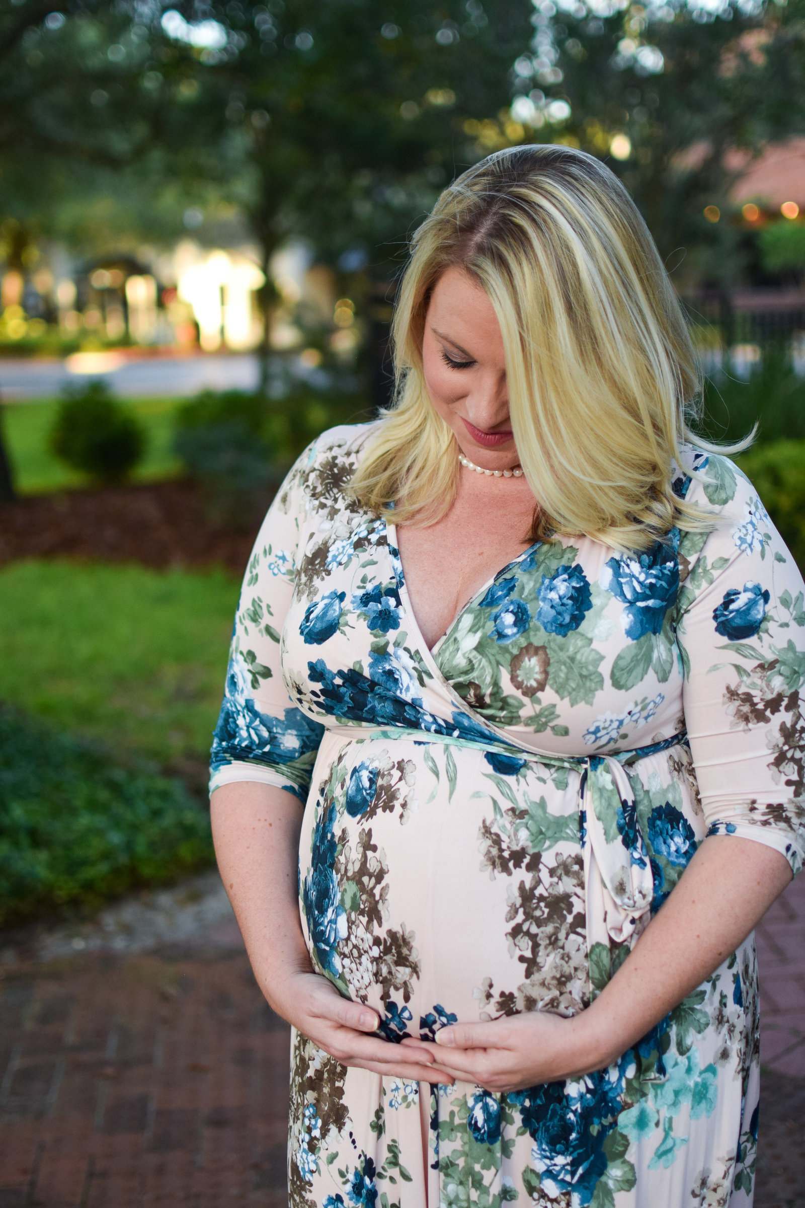 Maternity Pregnant Girl holding baby bump floral maxi dress  Windermere Florida