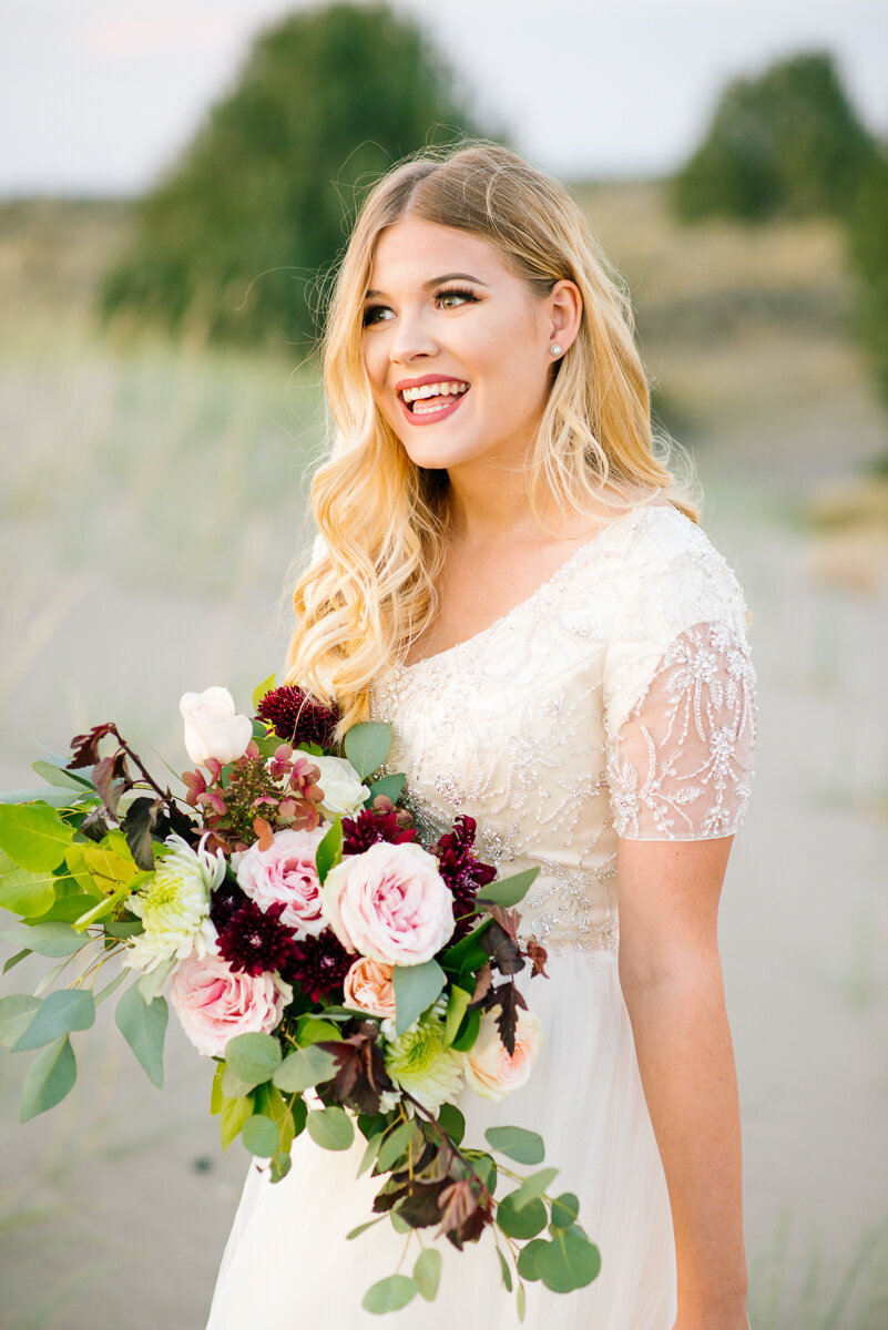 Jackson Hole photographers capture bride smiling during golden hour portraits