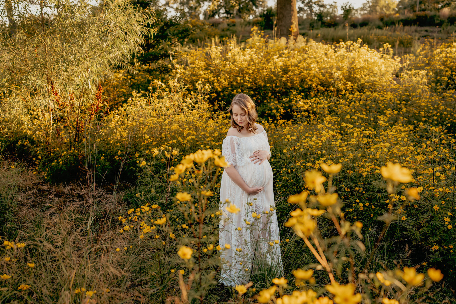 woan standing in yellow flowers field