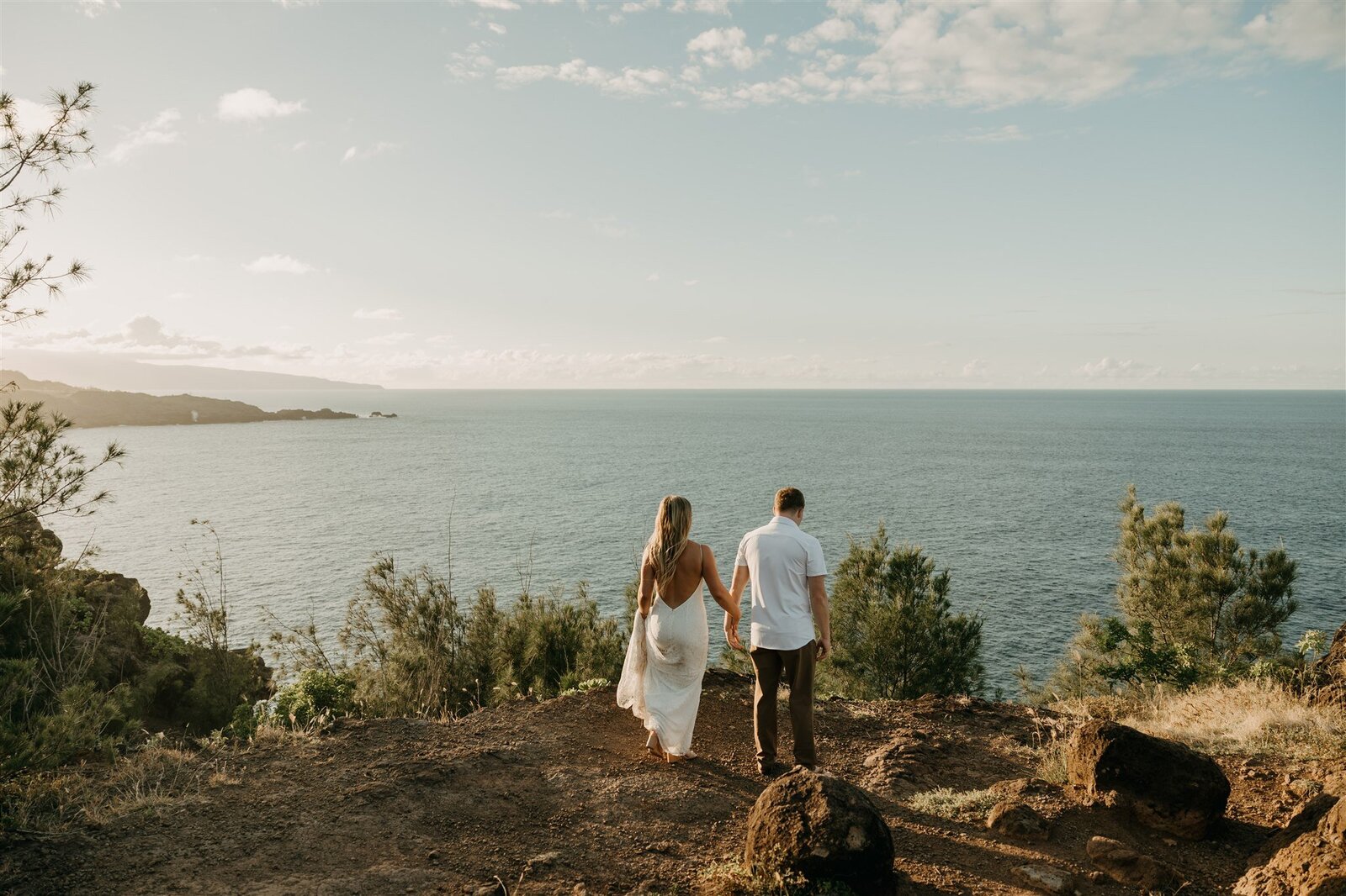 Elopement couple on coastal cliffside in Maui, Hawaii during sunset