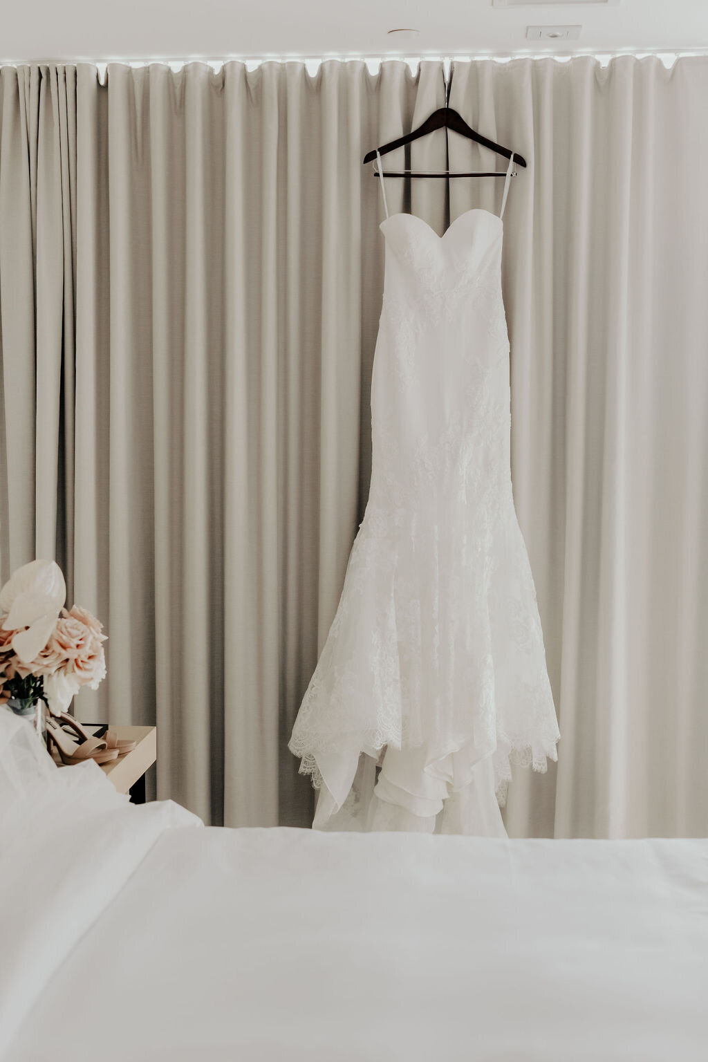 Wedding gown hanging in hotel