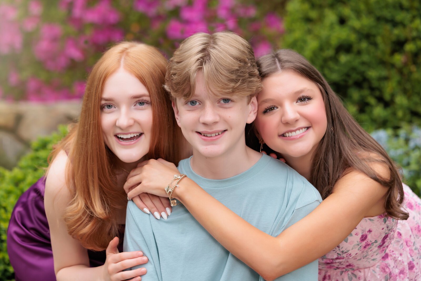 Siblings hugging in Duke Gardens during the senior's session.