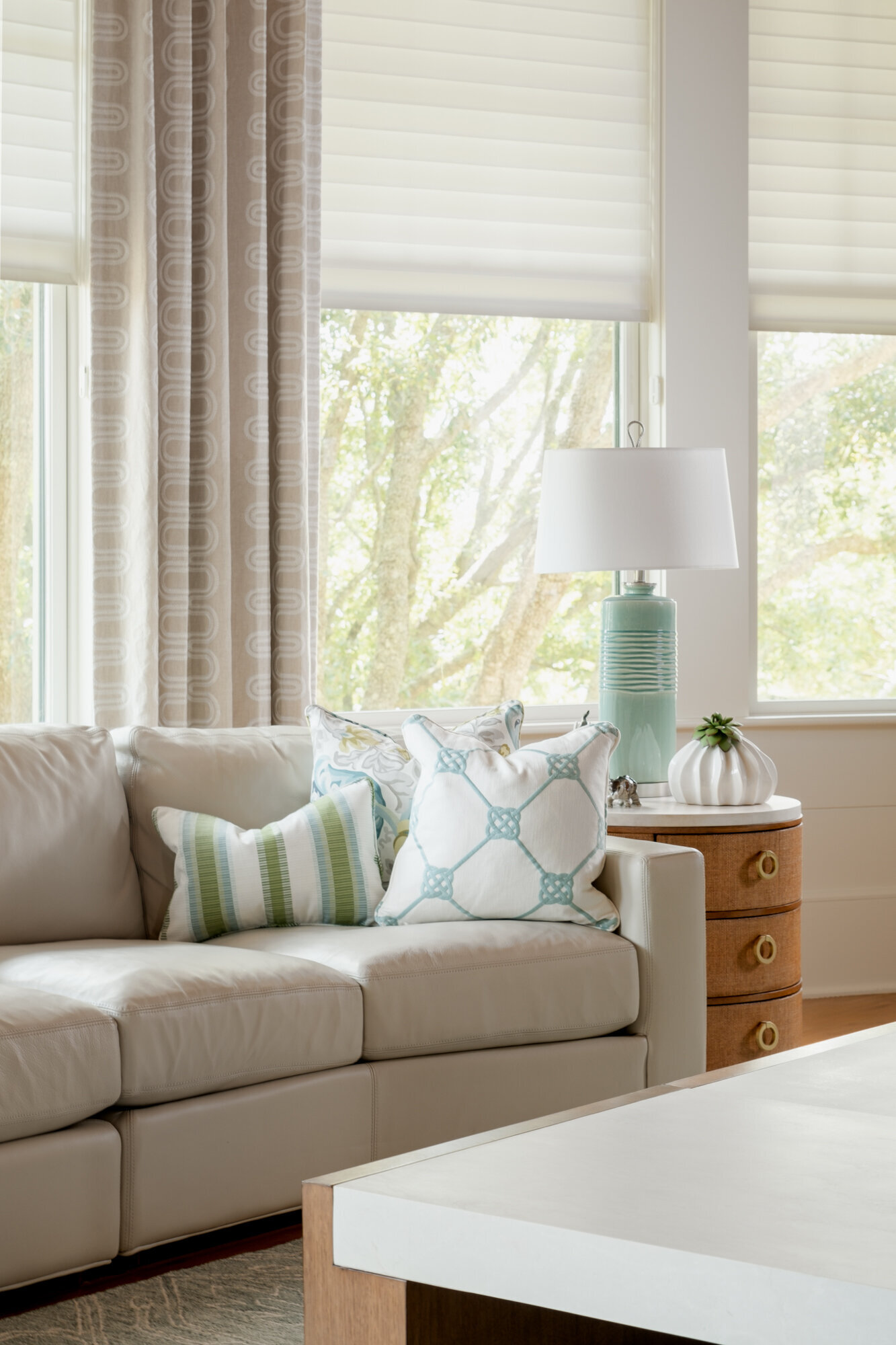 Living room remodel of a coastal home in Wilmington, NC, featuring serene, watery colors, updated flooring, and large windows framing stunning Intracoastal Waterway views."
