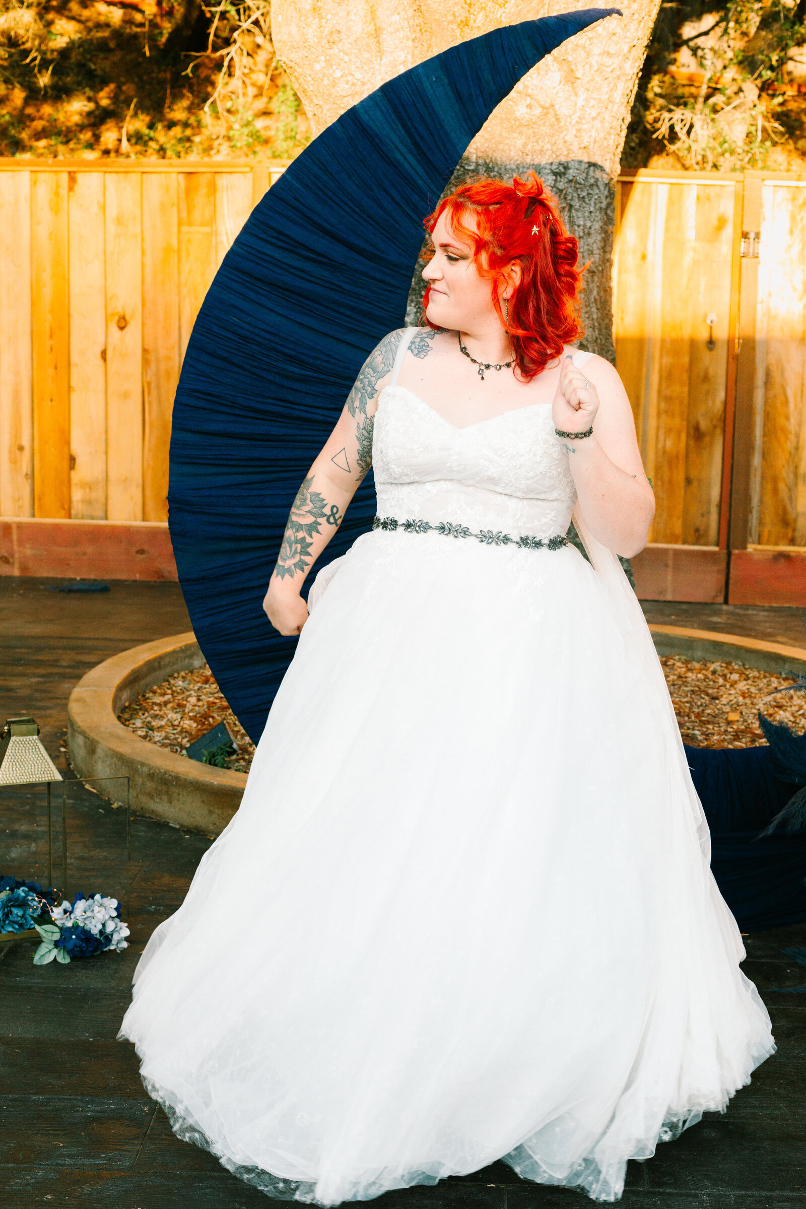 A tattooed bride dancing after her wedding ceremony.