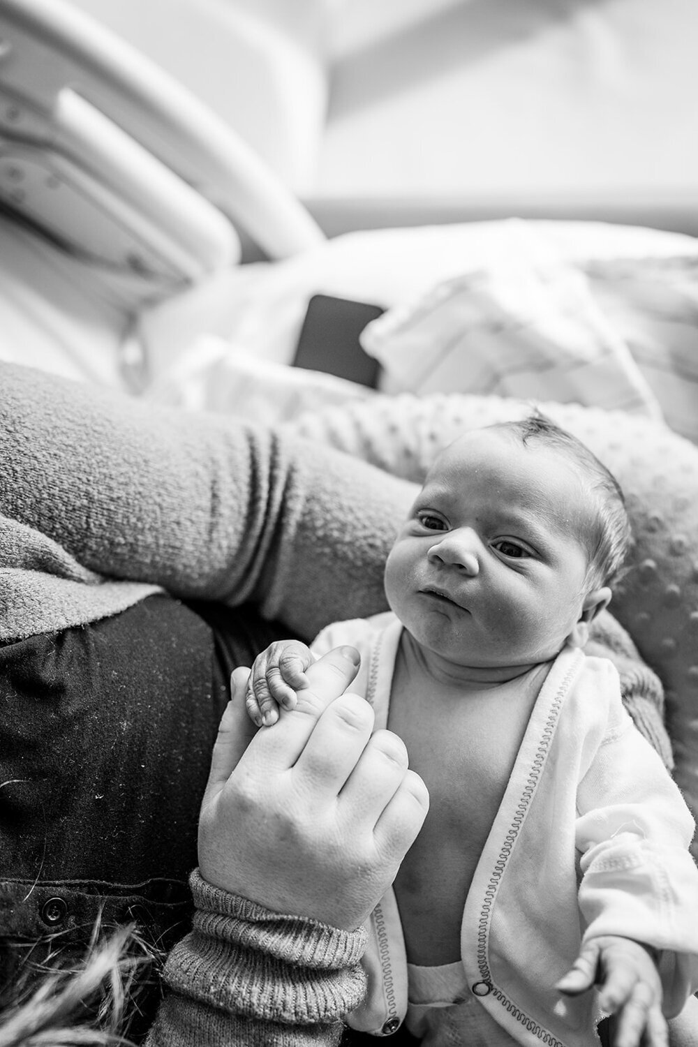 black and white portrait of baby boy looking up at mom from hospital bed