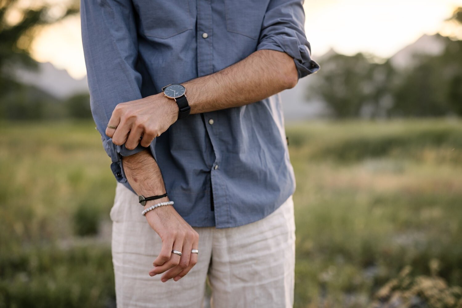 groom rolling up sleeves