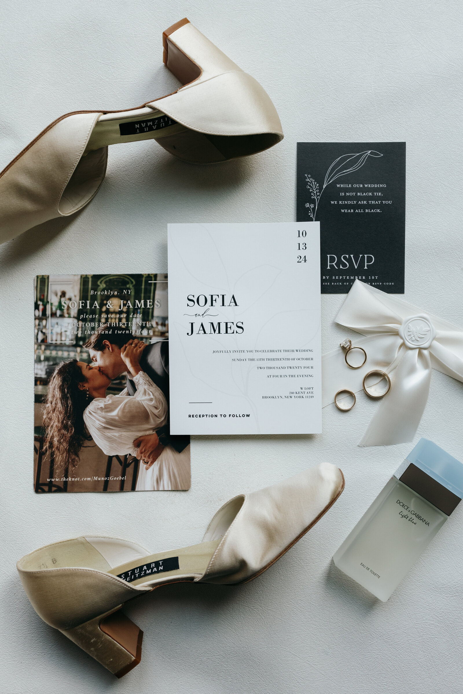 Flat lay of editorial style wedding with RSVP, wedding invitations, wedding shoes, cologne, and wedding and engagement rings | Emma LeeAnn Photography