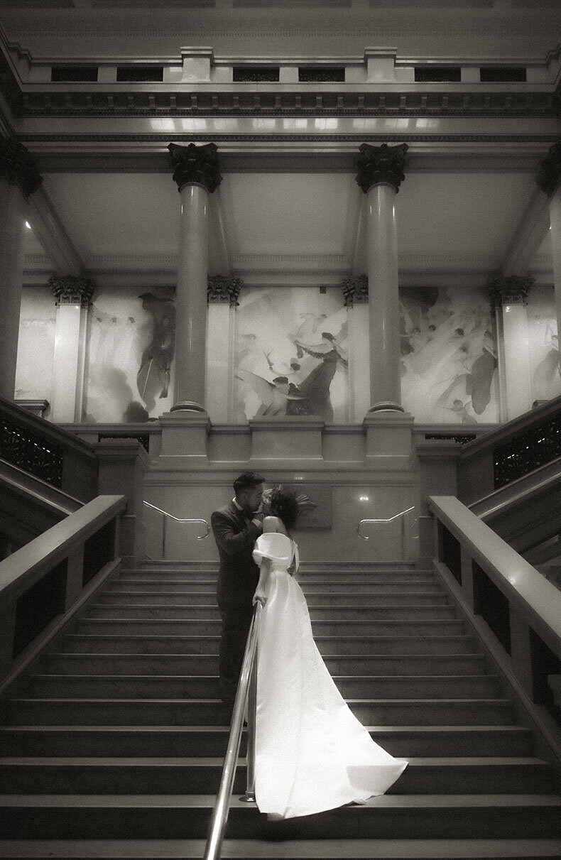 Bride and Groom Kissing at Grand Staircase in Carnegie Museum of Art Wedding