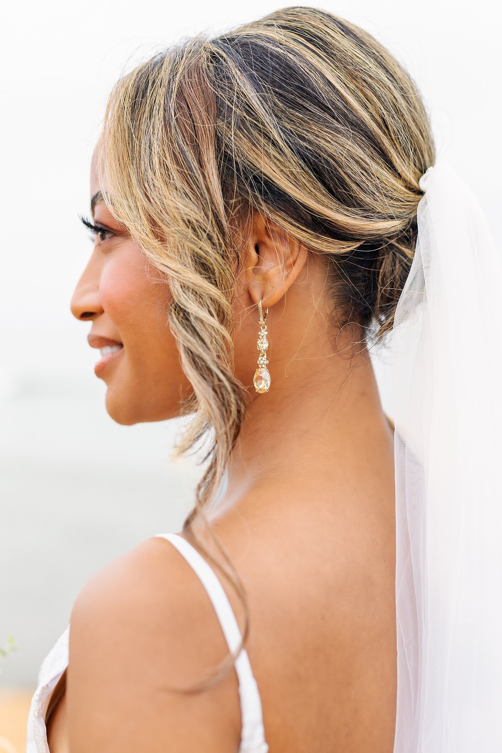 Bride wearing crystal earring at Pelican Hill weddings in Newport Beach, California.