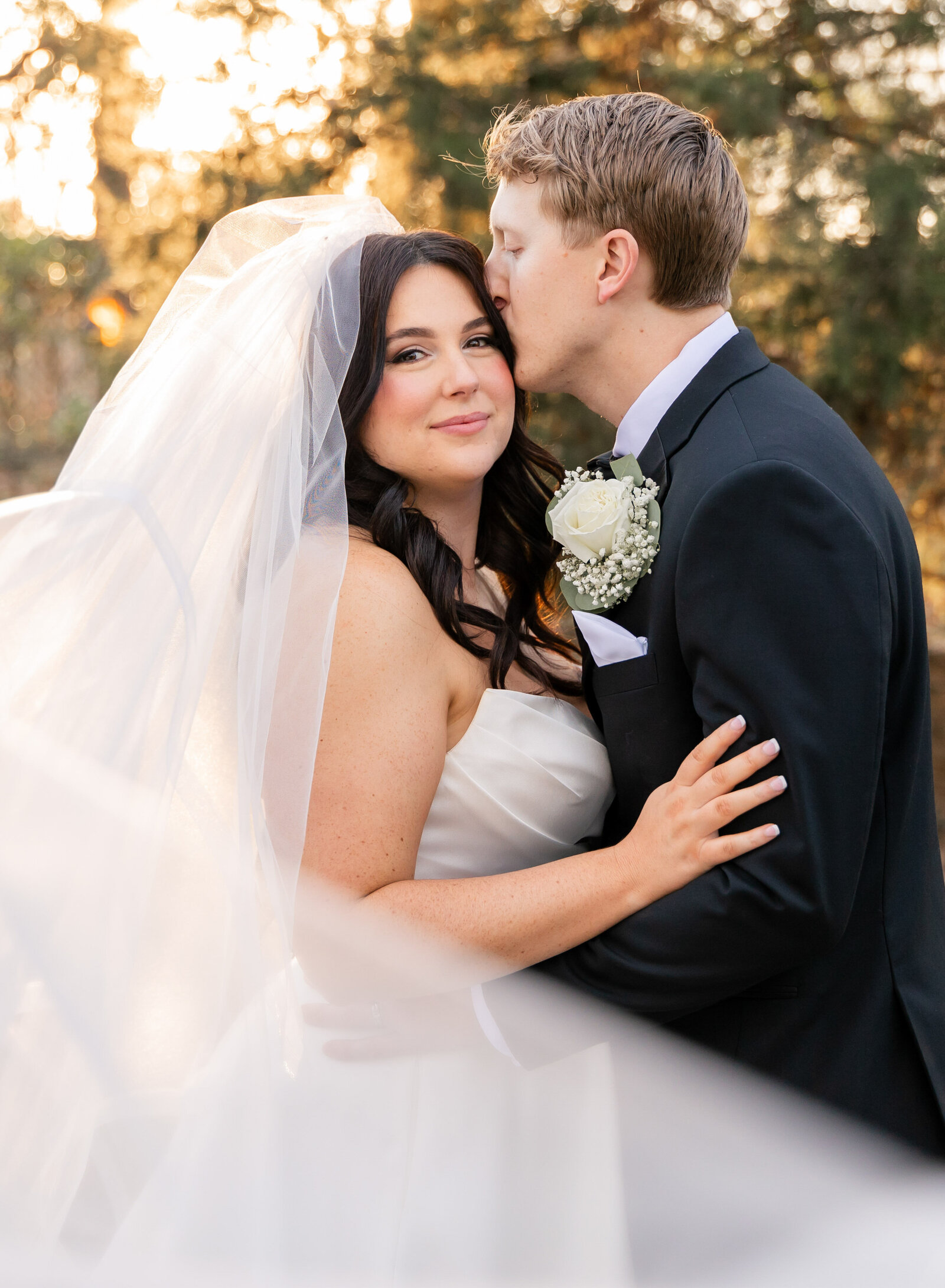 groom kissing his bride