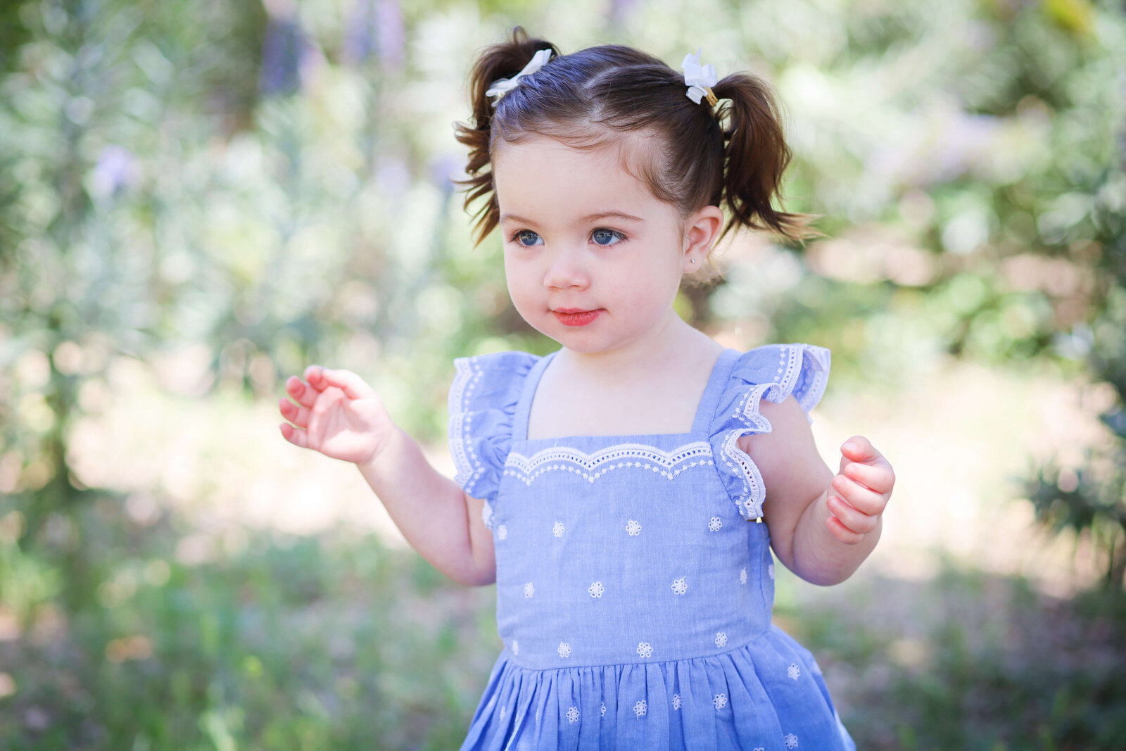 Weddings and Family Portraits in Orange County little girl wearing purple dress