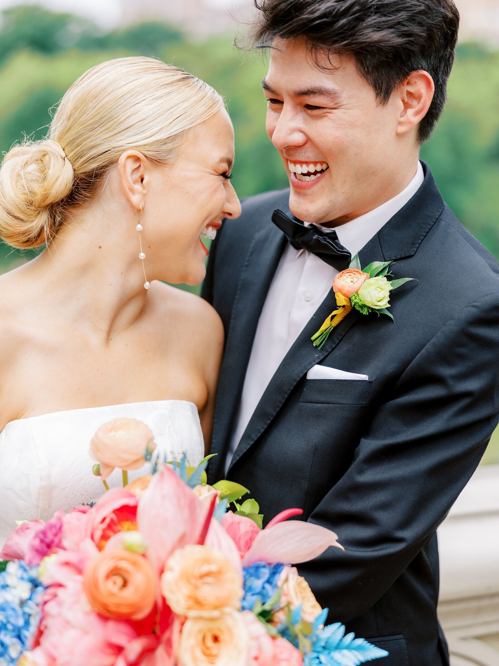 Bride and Groom laughing together at Bow Bridge in Central Park, New York City