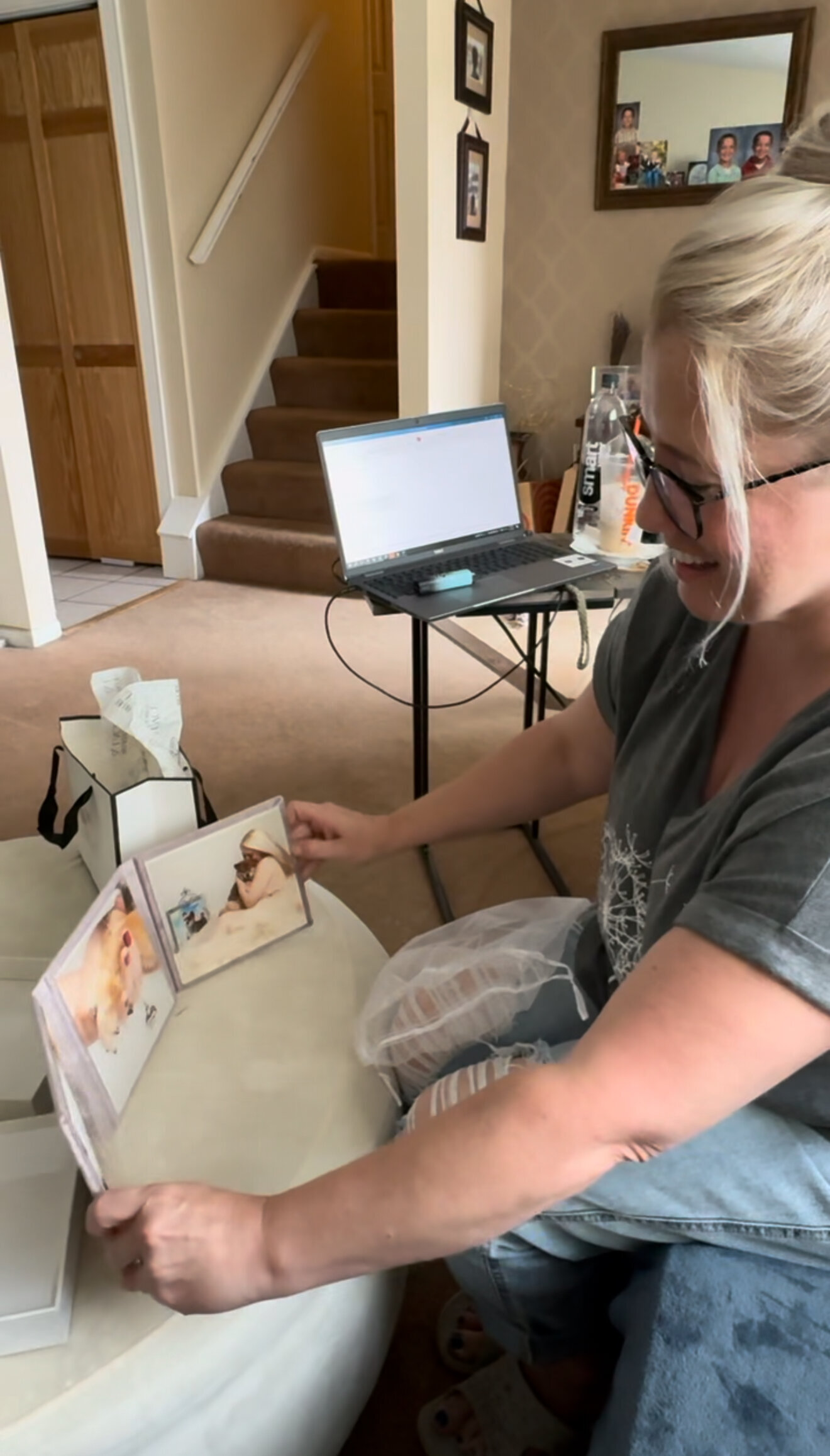 Dog mom maternity photos in trifold in her home
