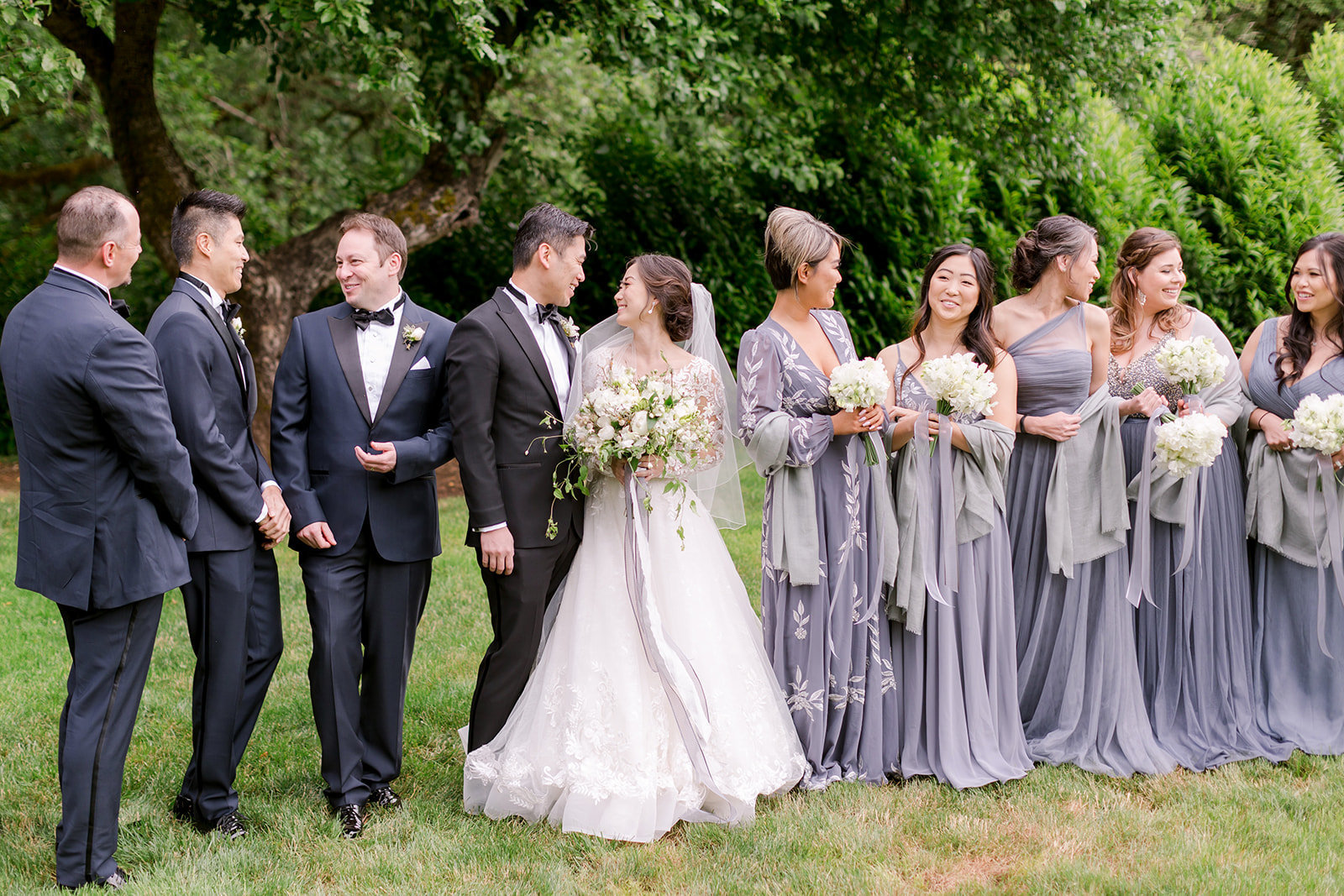 Bridesmaids and groomsmen smiling and happy