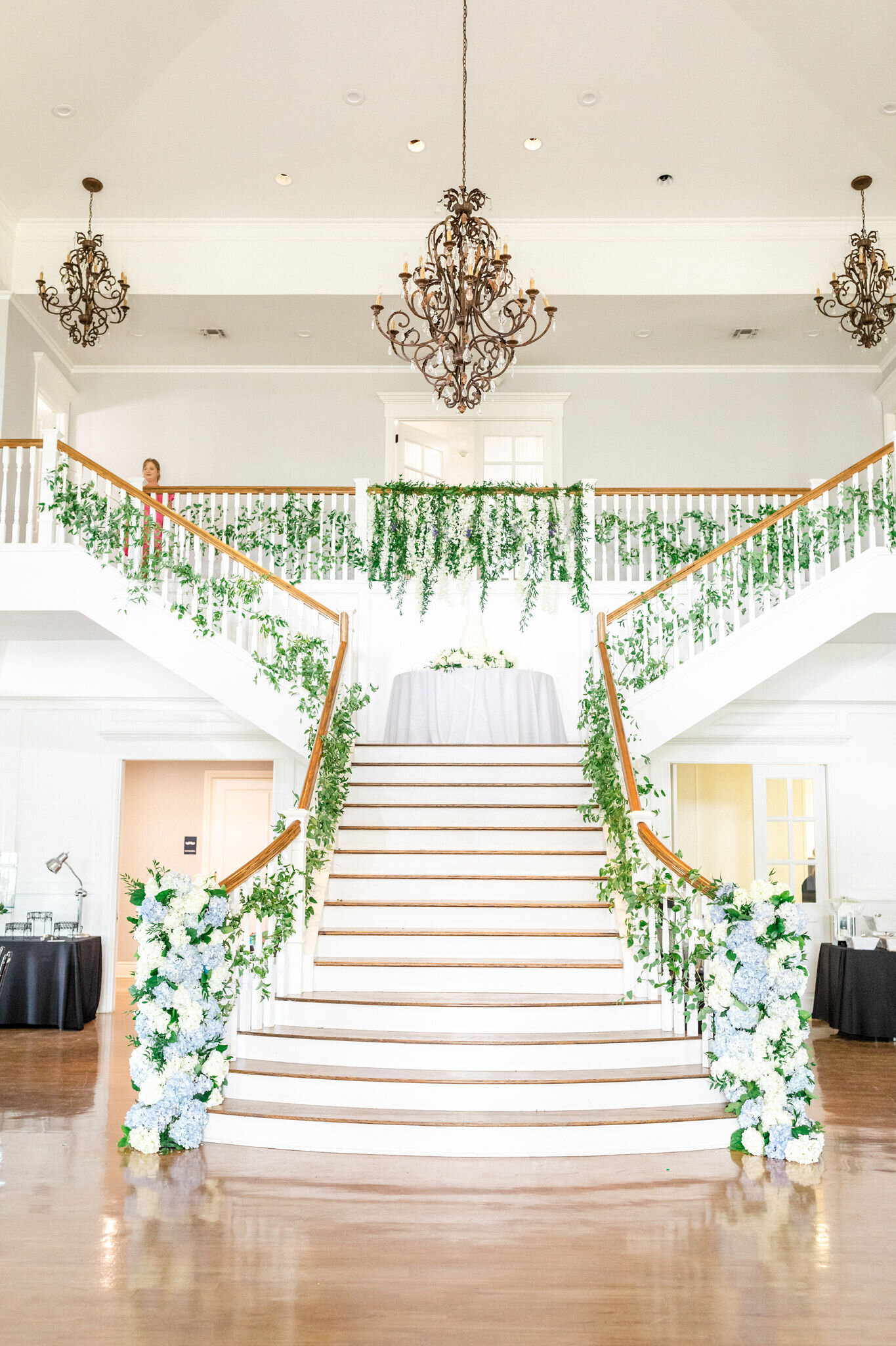 The Kendall Point grand staircase decorated with flowers.