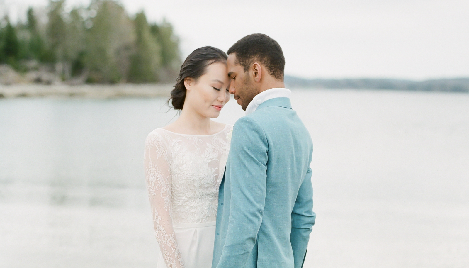Couple in bridal attire on beach in St Margaret's Bay,  Halifax