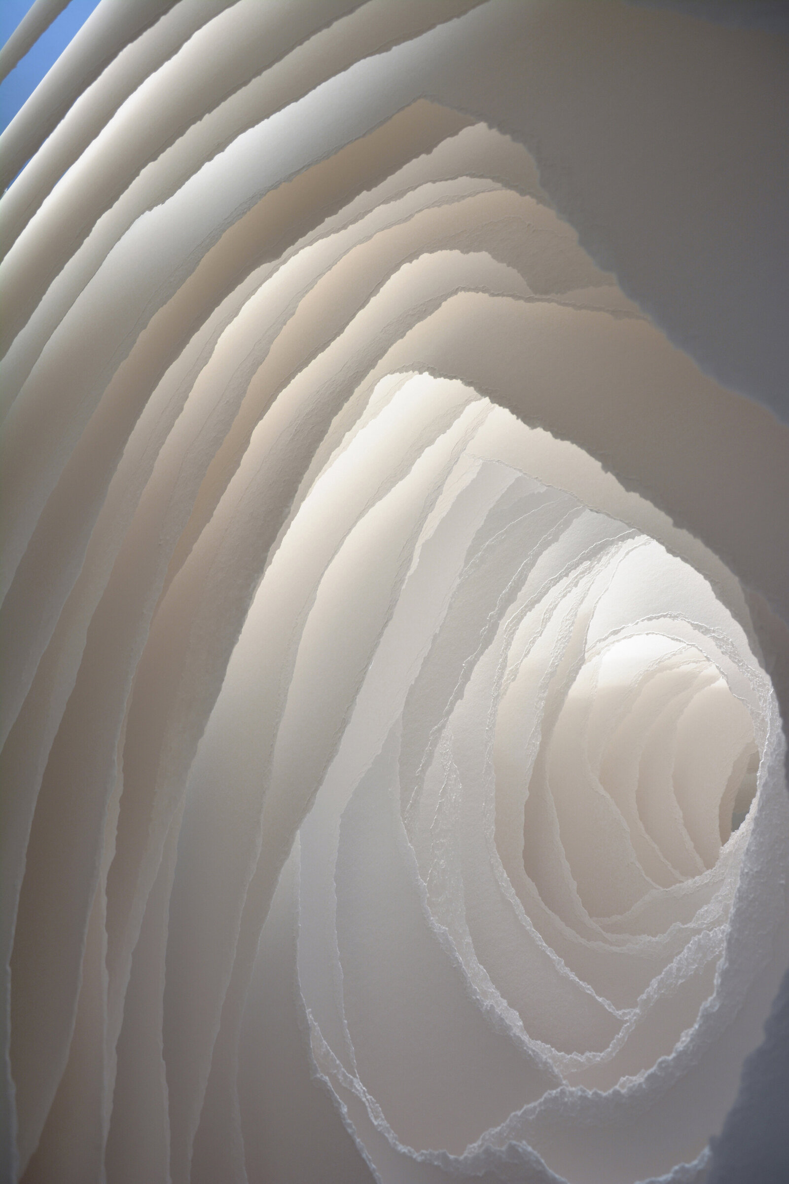 Sculpture of layers of paper torn into holes diminishing in size. Artwork titled Terforation by Angela Glajcar.