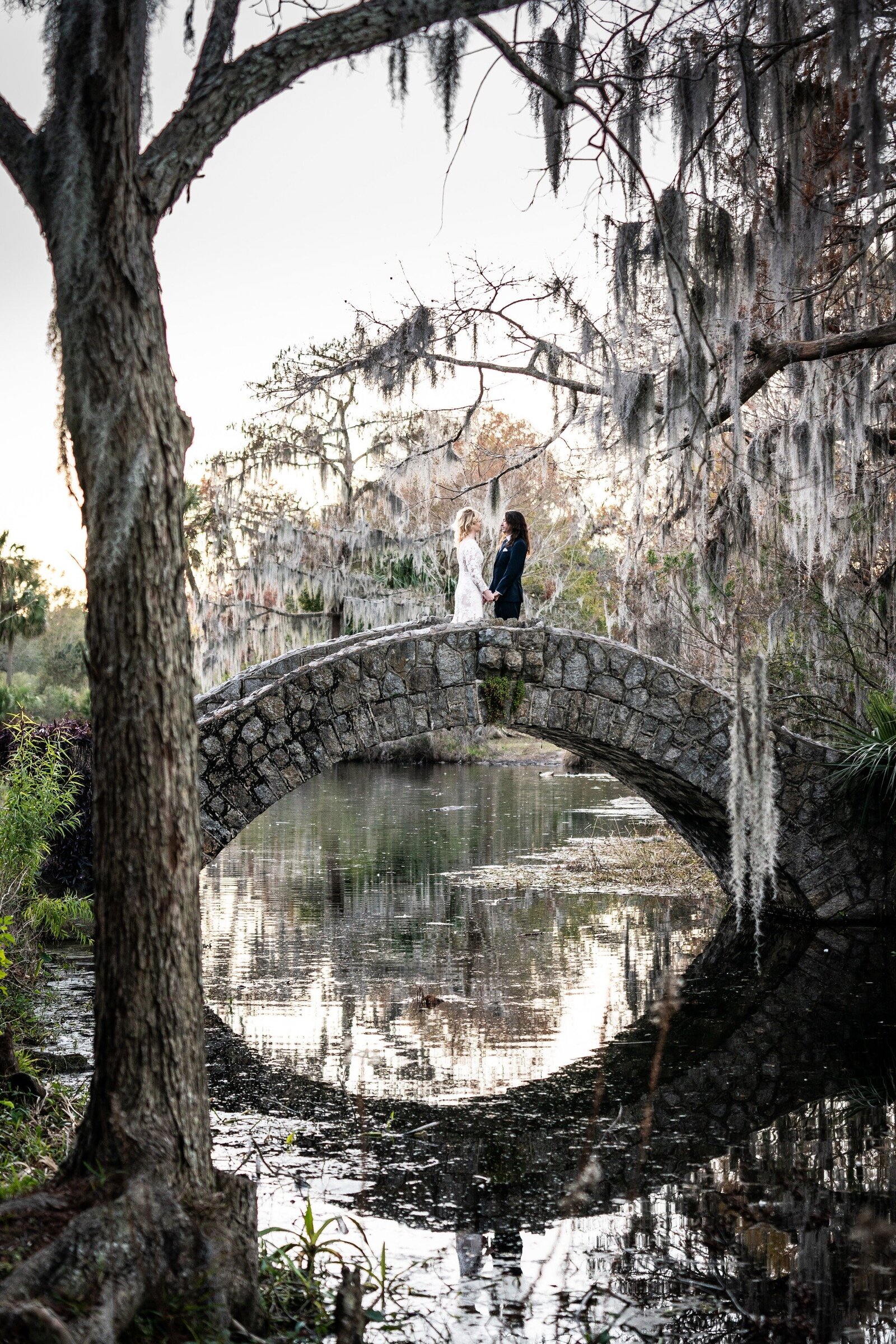 Bride and groom at top of Langles Bridge in New Orleans City Park