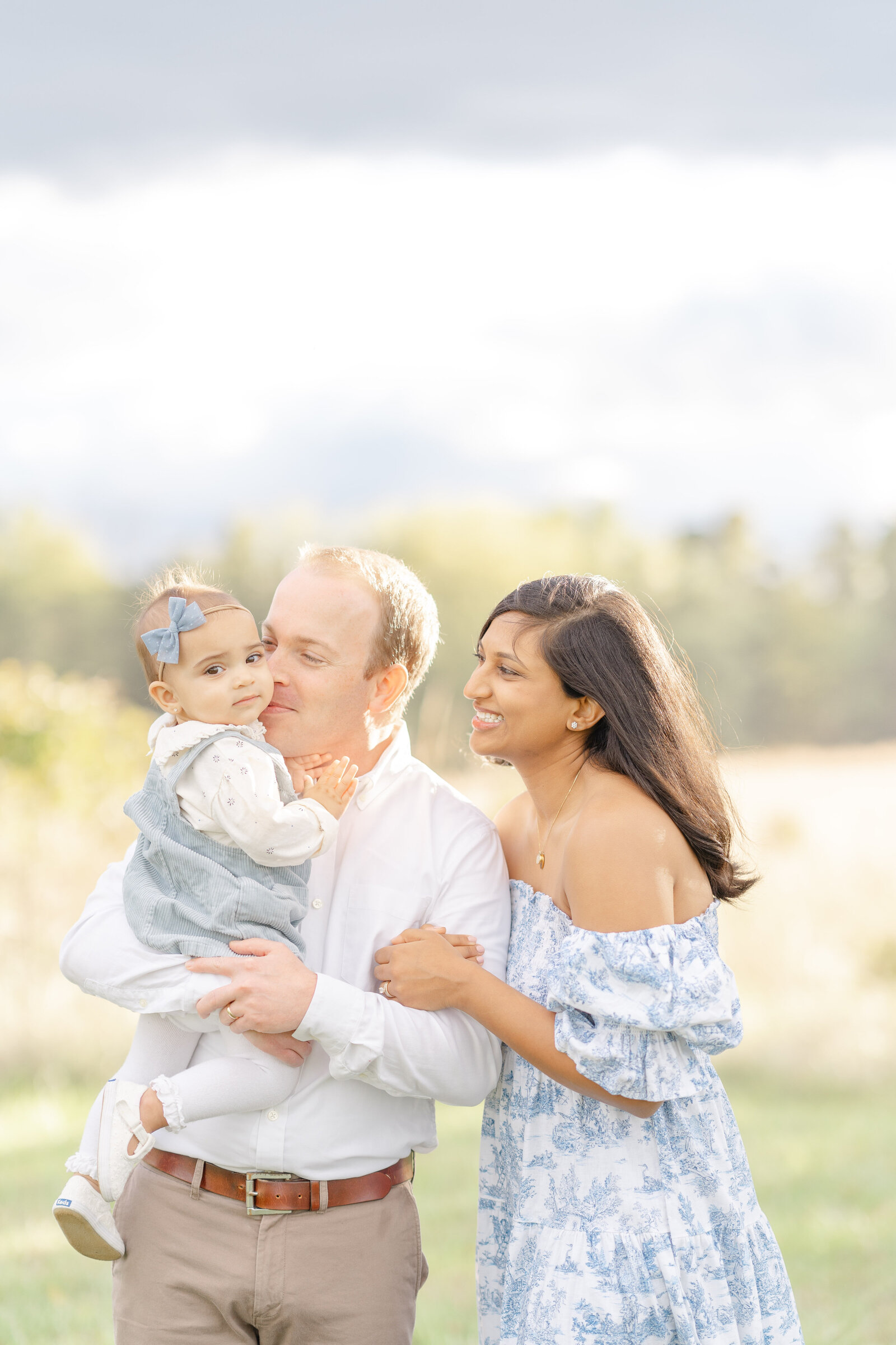 dad and mom look at baby adoringly taken by Sterling, Virginia family photographer