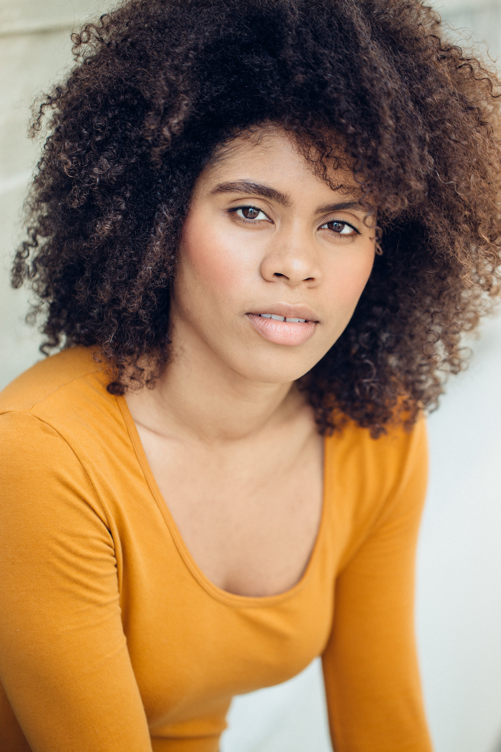 Headshot Photo Of Young Woman In Orange Long Sleeves