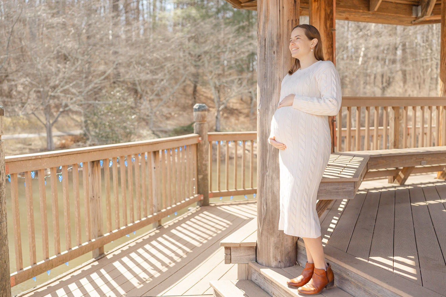 mom leaning on a pole taken by TBP, a Reston, VA maternity photographer
