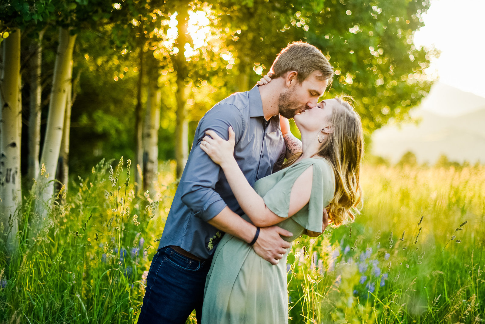 Flagstaff wildflowers aspens couple kissing engagement photography at Snowbowl Lodge