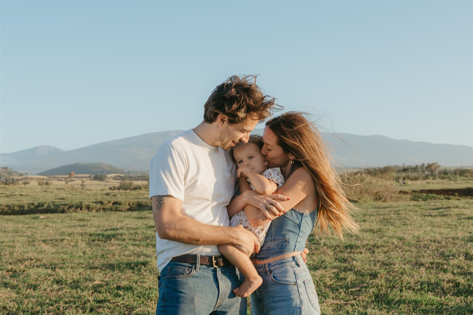 Parents and children embracing during a styled family photo shoot in Maui, golden hour editorial session.