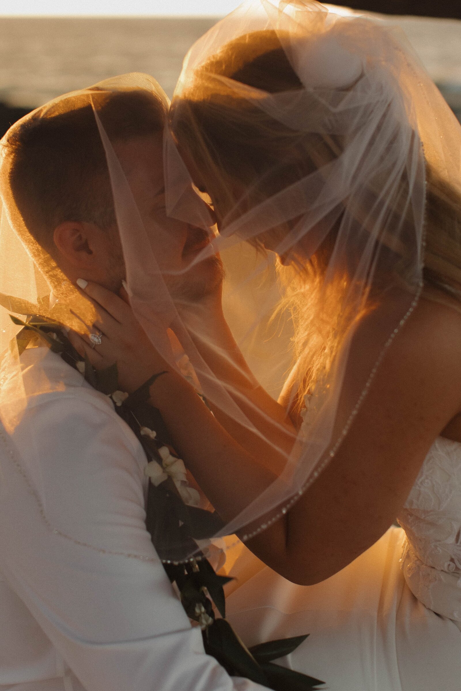 bride and groom eloping in hawaii at sunset