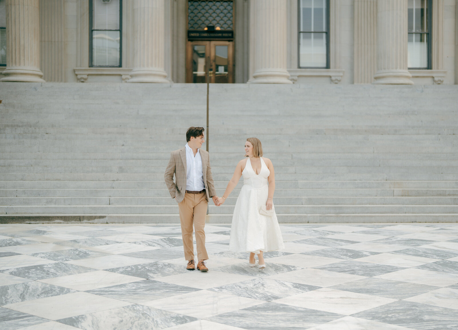 bride and groom at charleston county courthouse taking engagement photos 