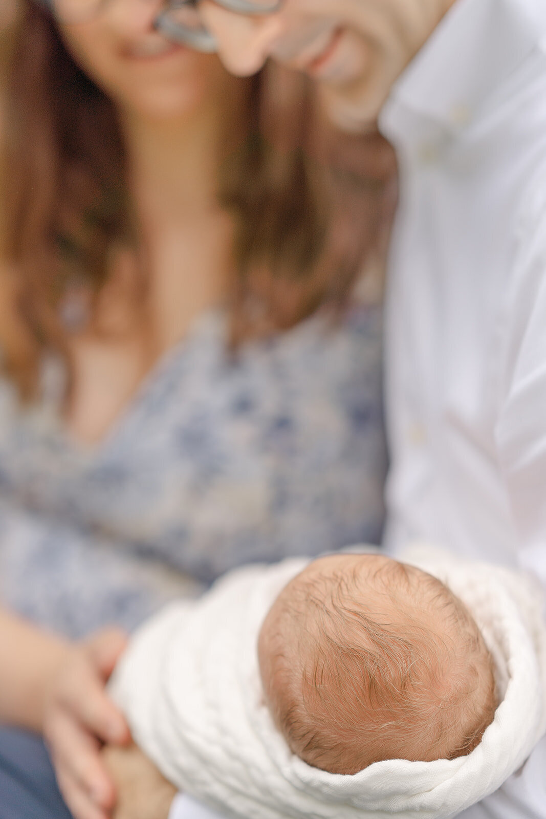 baby held by parents taken by TBP, a newborn photographer in Leesburg, Virginia