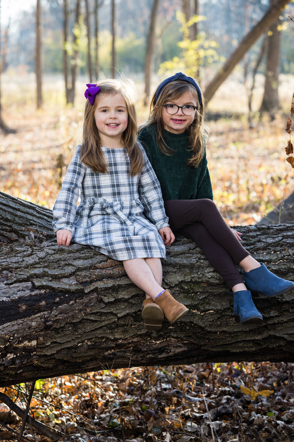 two children sitting on a lodge in an outdoor setting