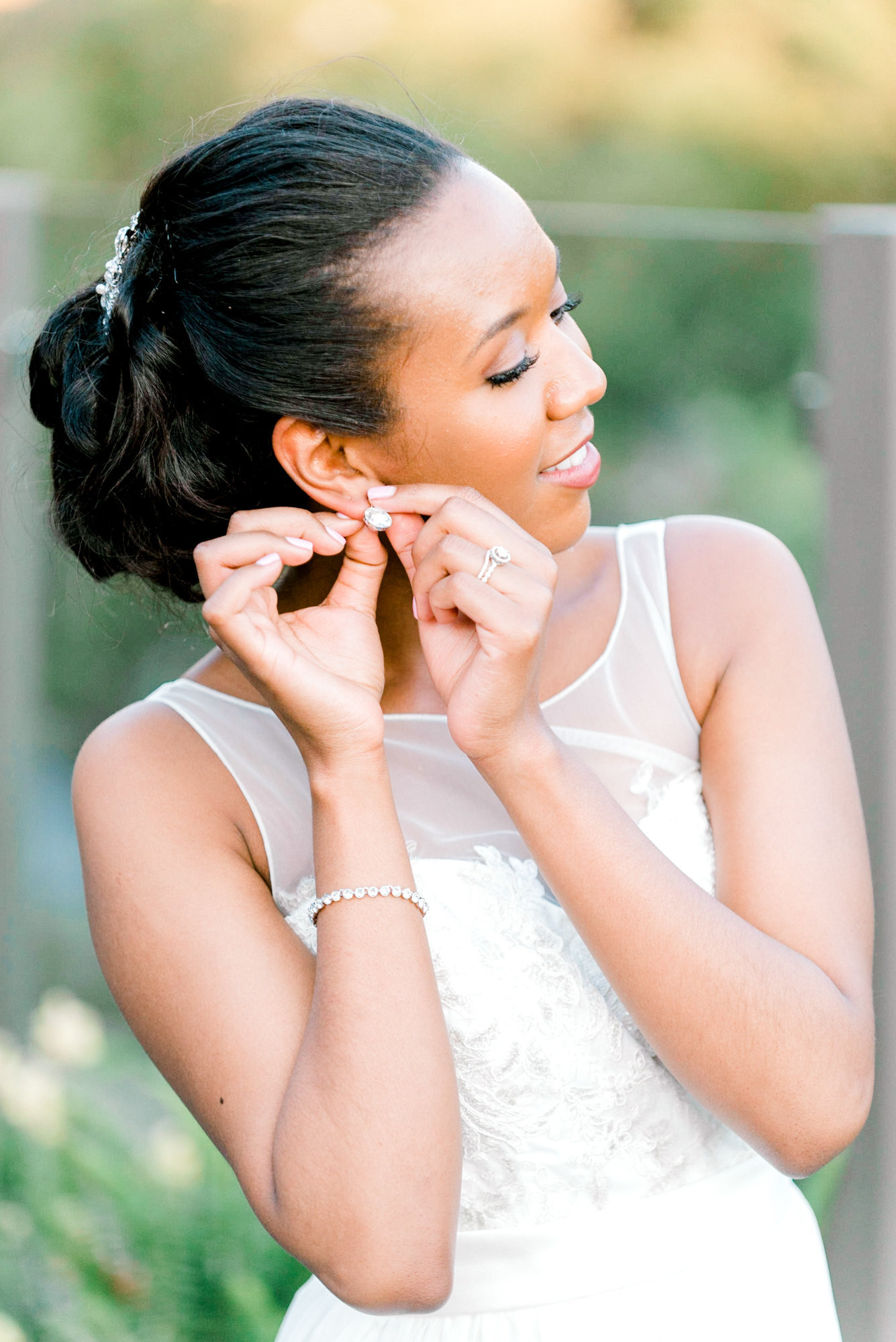 bride putting jewlery on picture by Chicago wedding photographer