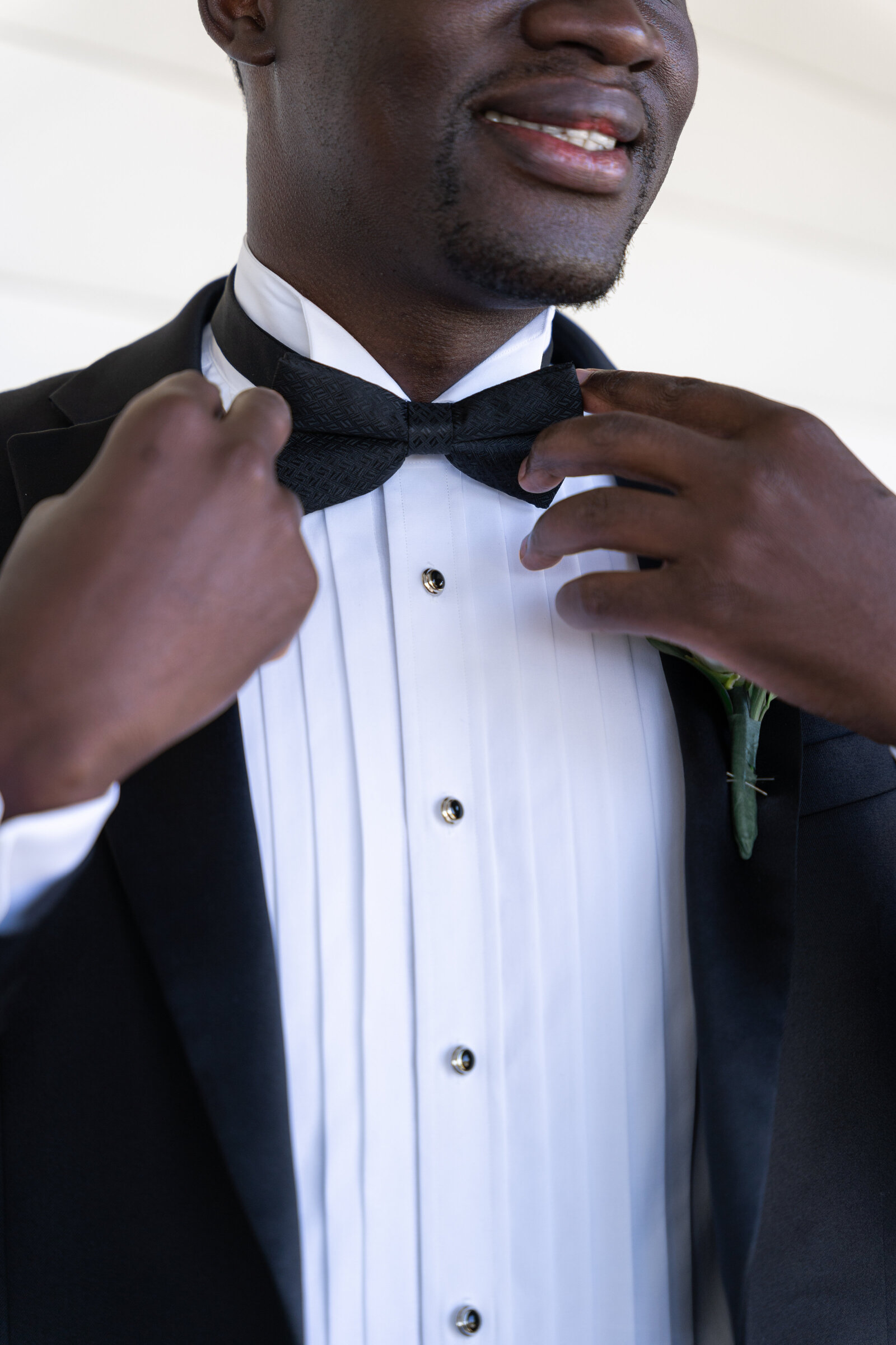 african american man putting on tuxedo bowtie the breakers spring lake