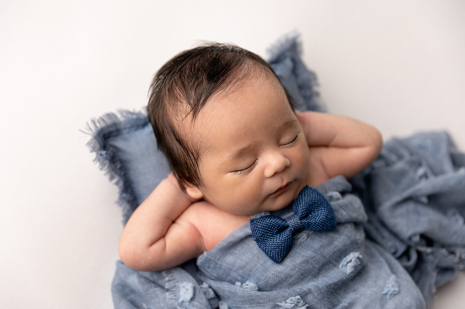 baby in blue sleeping by Newborn Photography Bucks County PA
