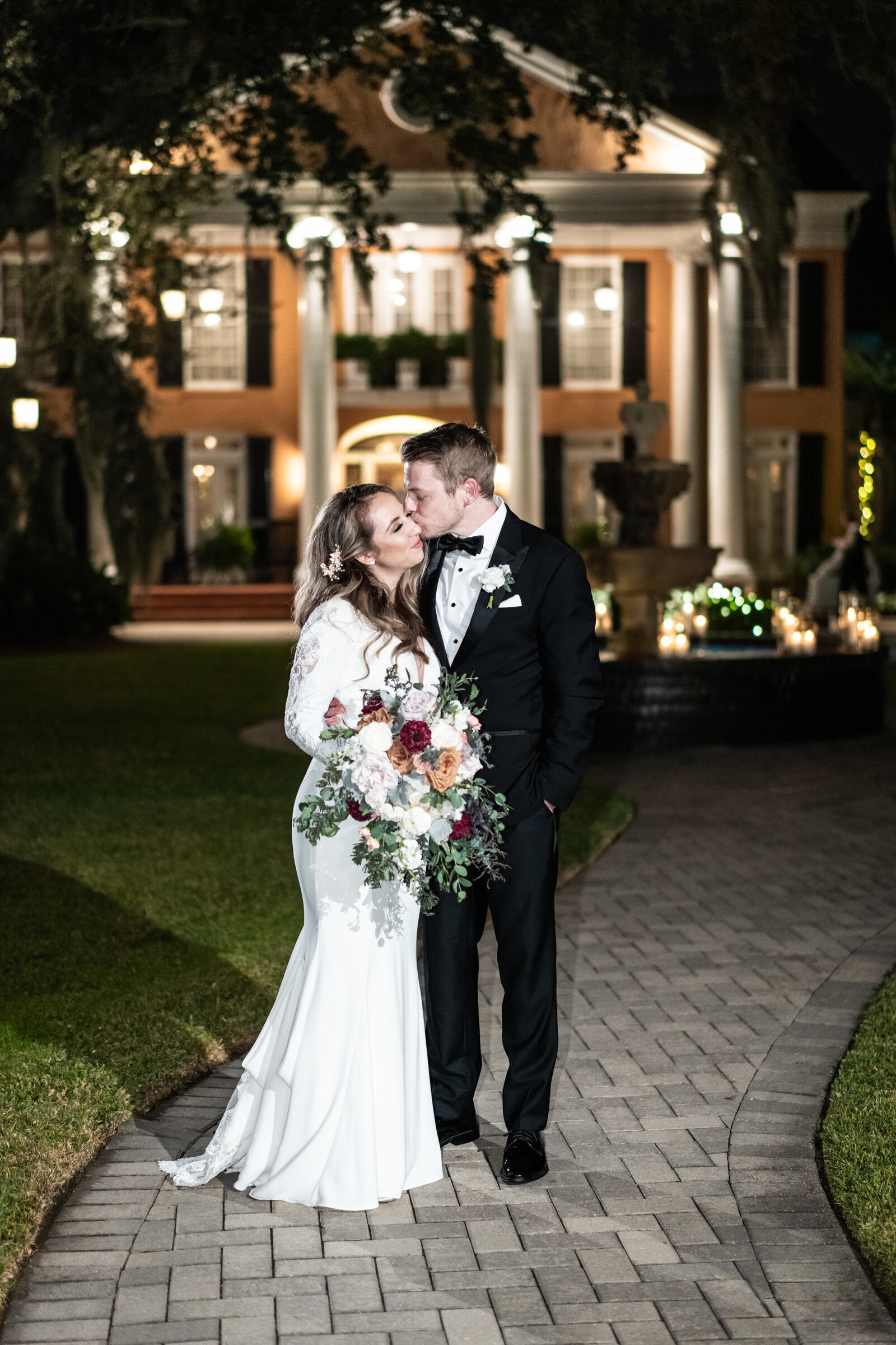 Groom kisses bride at Southern Oaks wedding in New Orleans