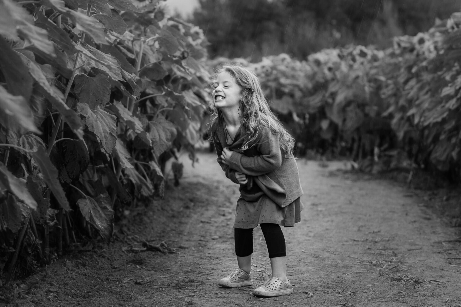 Black and White photo of girl in sunflower field by Jennifer Gilbert in Tottenham Ontario.
