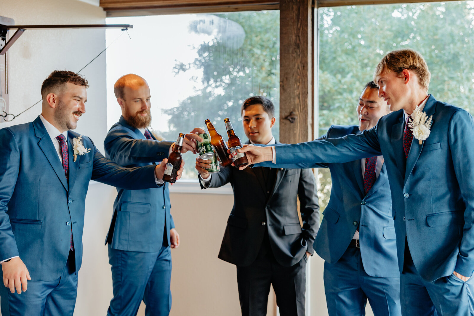 Denver Wedding Photographer captures groom and groomsmen toasting